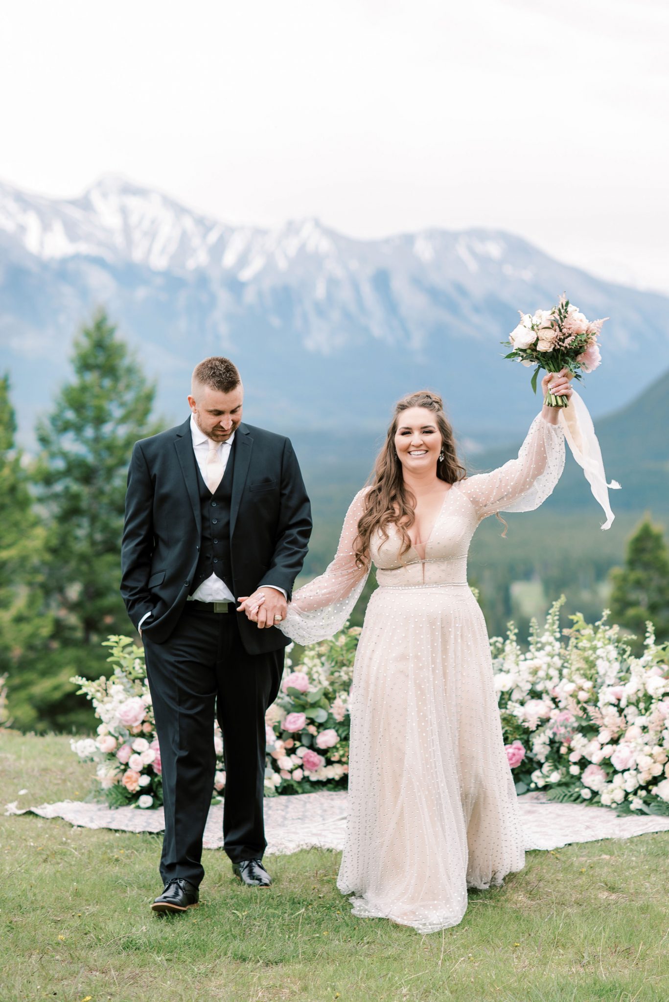 Bride and groom celebrate their elopement at Tunnel Mountain Reservoir in Banff National Park