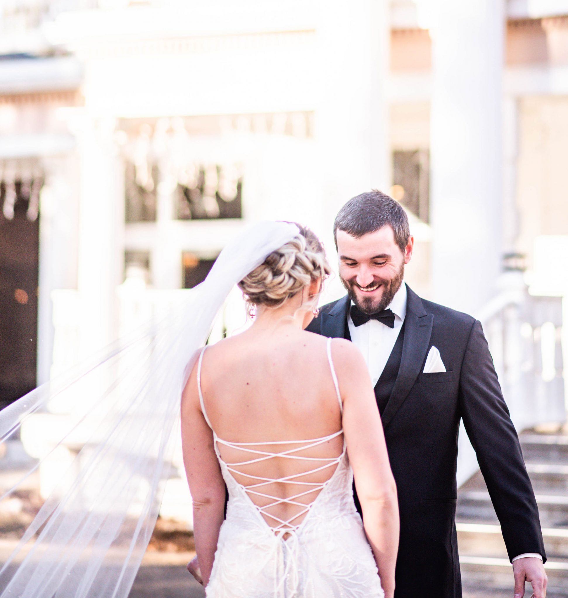 Classic bride and groom share a first look in front of the balcony at the Norland Historic Estate Venue
