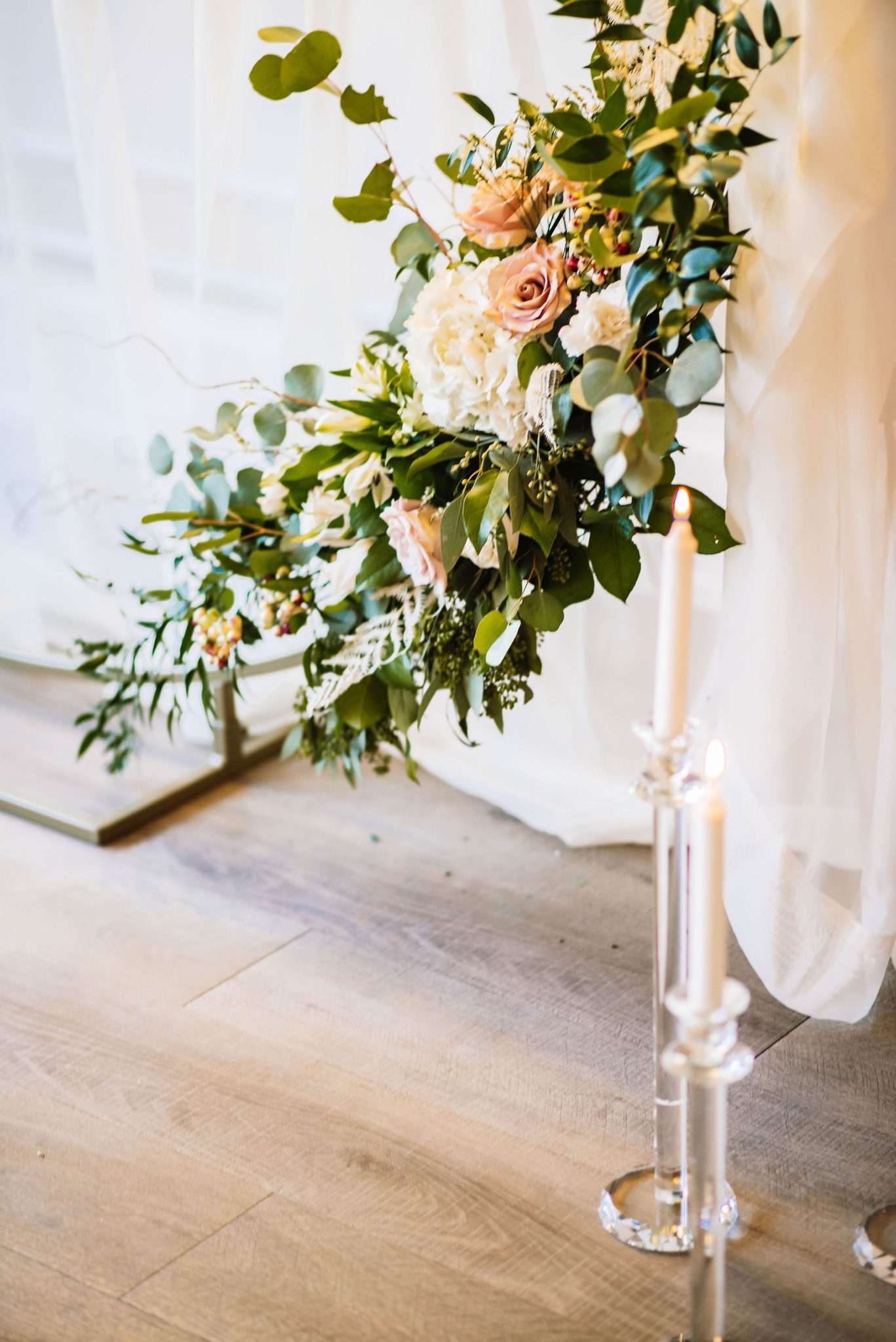 Enchanting ballroom wedding design inspiration with lush greenery and classic candles