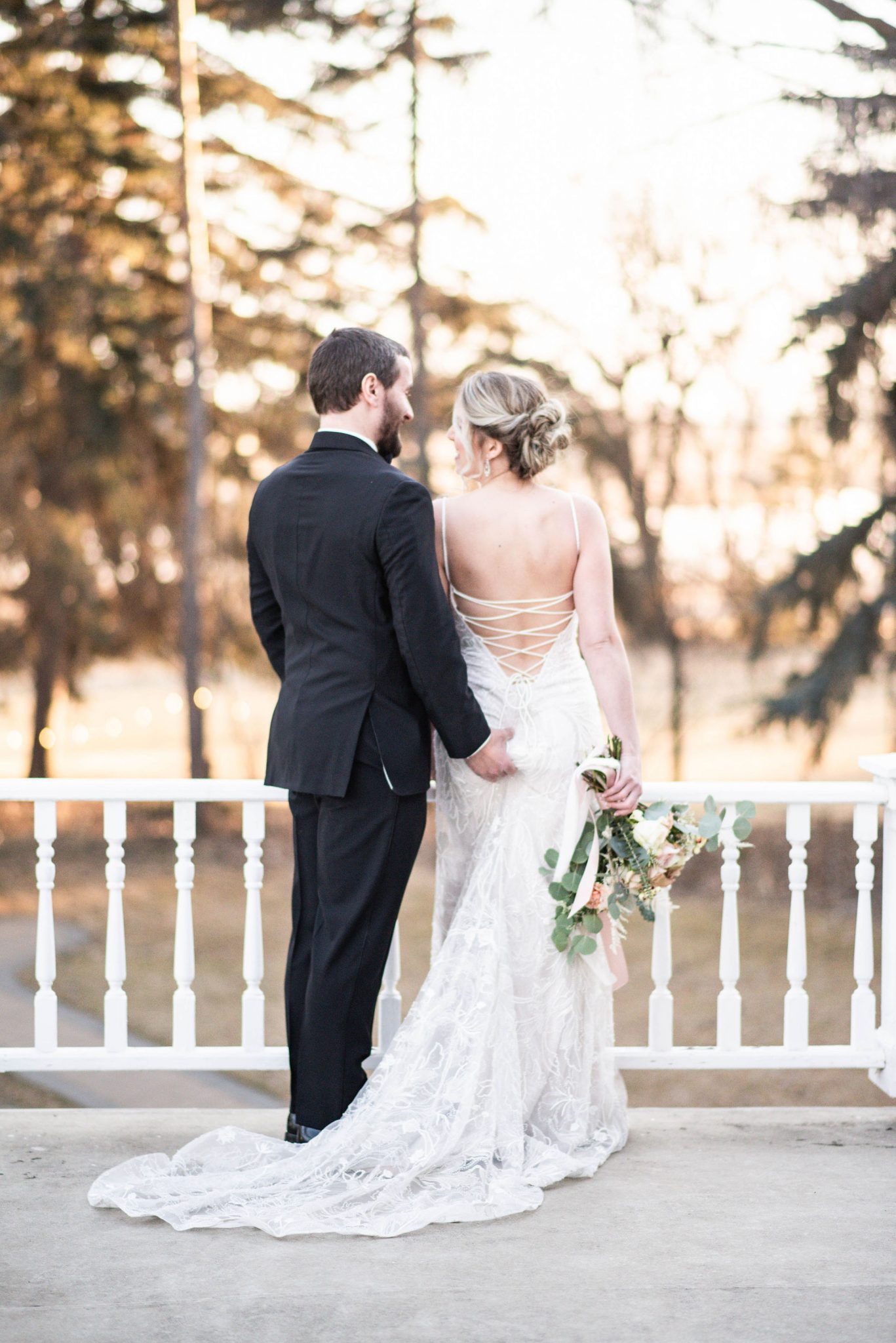 Bride and groom pose together on the balcony of the Norland Historic Estate Venue