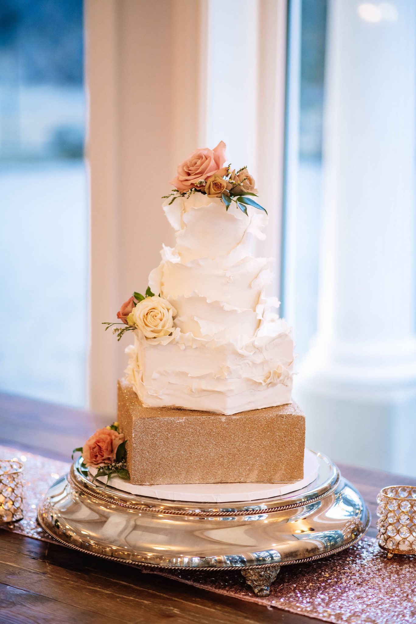 Soft white ruffle icing and metallic gold accents on this three tier wedding cake for an enchanting ballroom wedding at the Norland Historic Estate