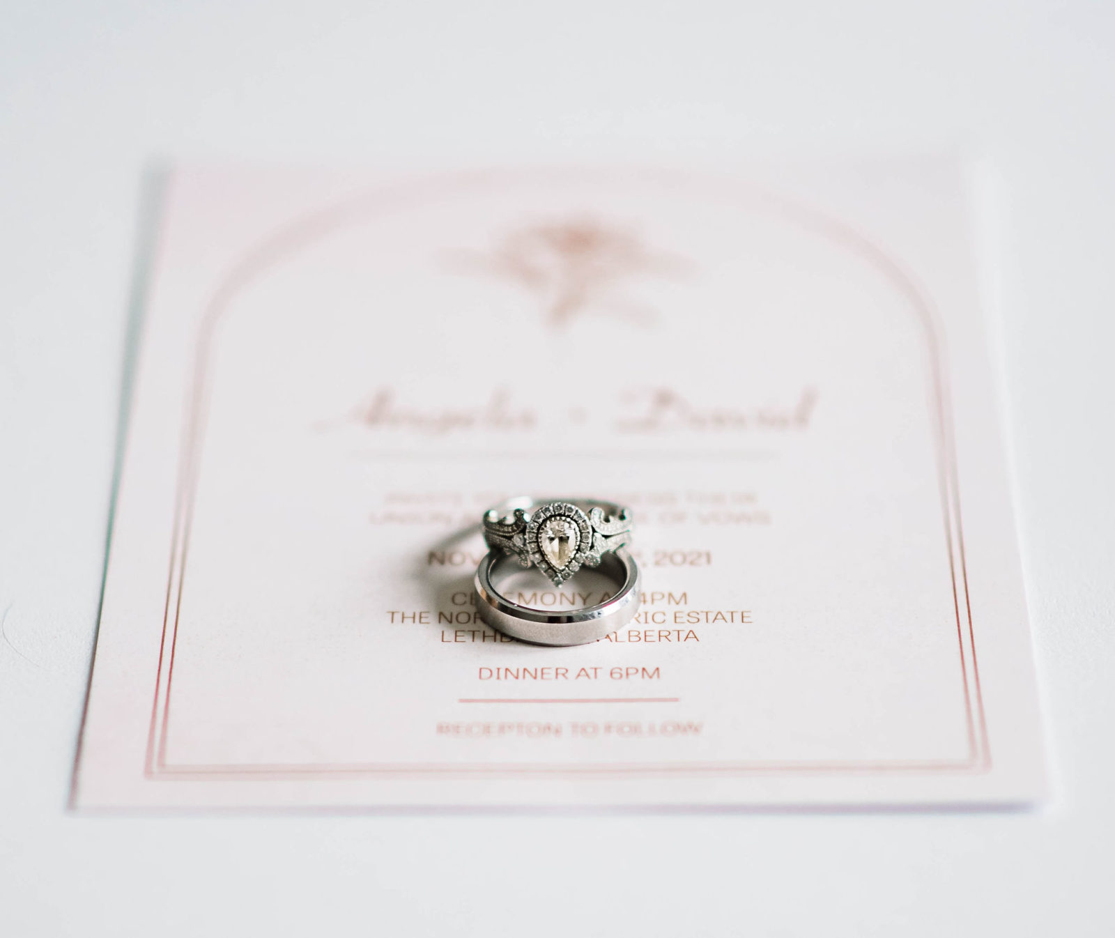 Vera Wang engagement ring photographed on white and pink classic wedding stationery