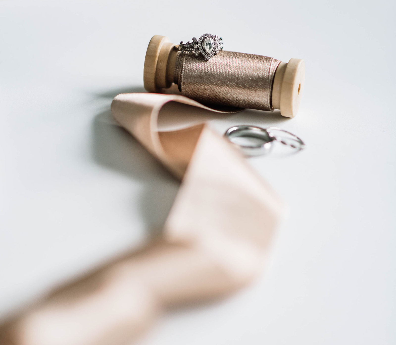 Vera Wang engagement ring on a spool of bronze metallic silk ribbon