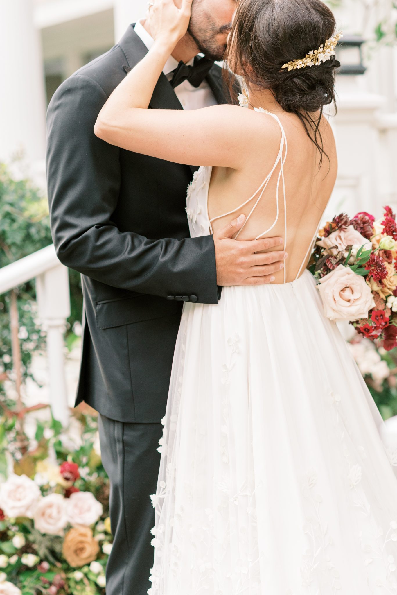 Bride and groom share a kiss in this enchanting estate wedding with berry and honey flowers