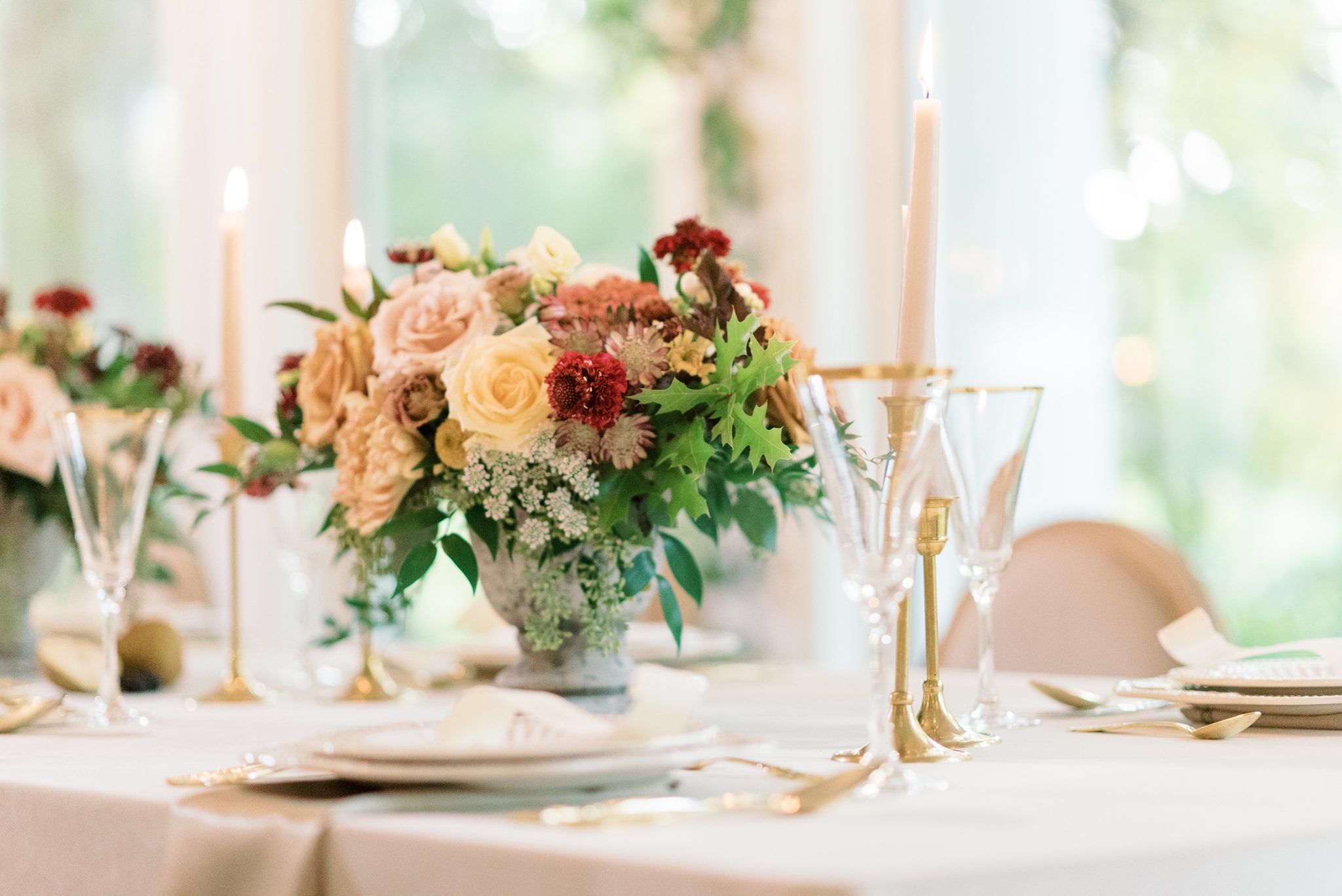 Floral centerpieces featuring honey and berry tones for an enchanting estate wedding