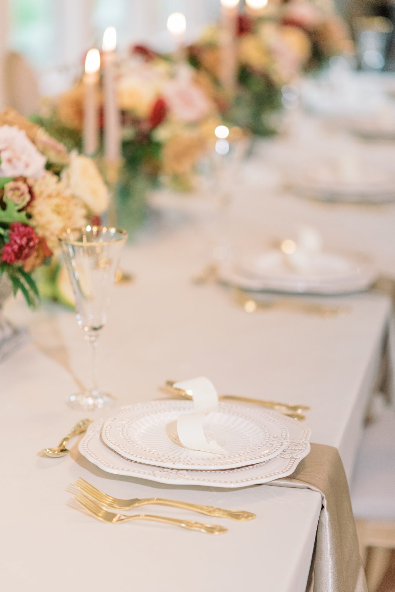 Wedding decor inspiration for an elegant and enchanting tablescape with gold and berry hues