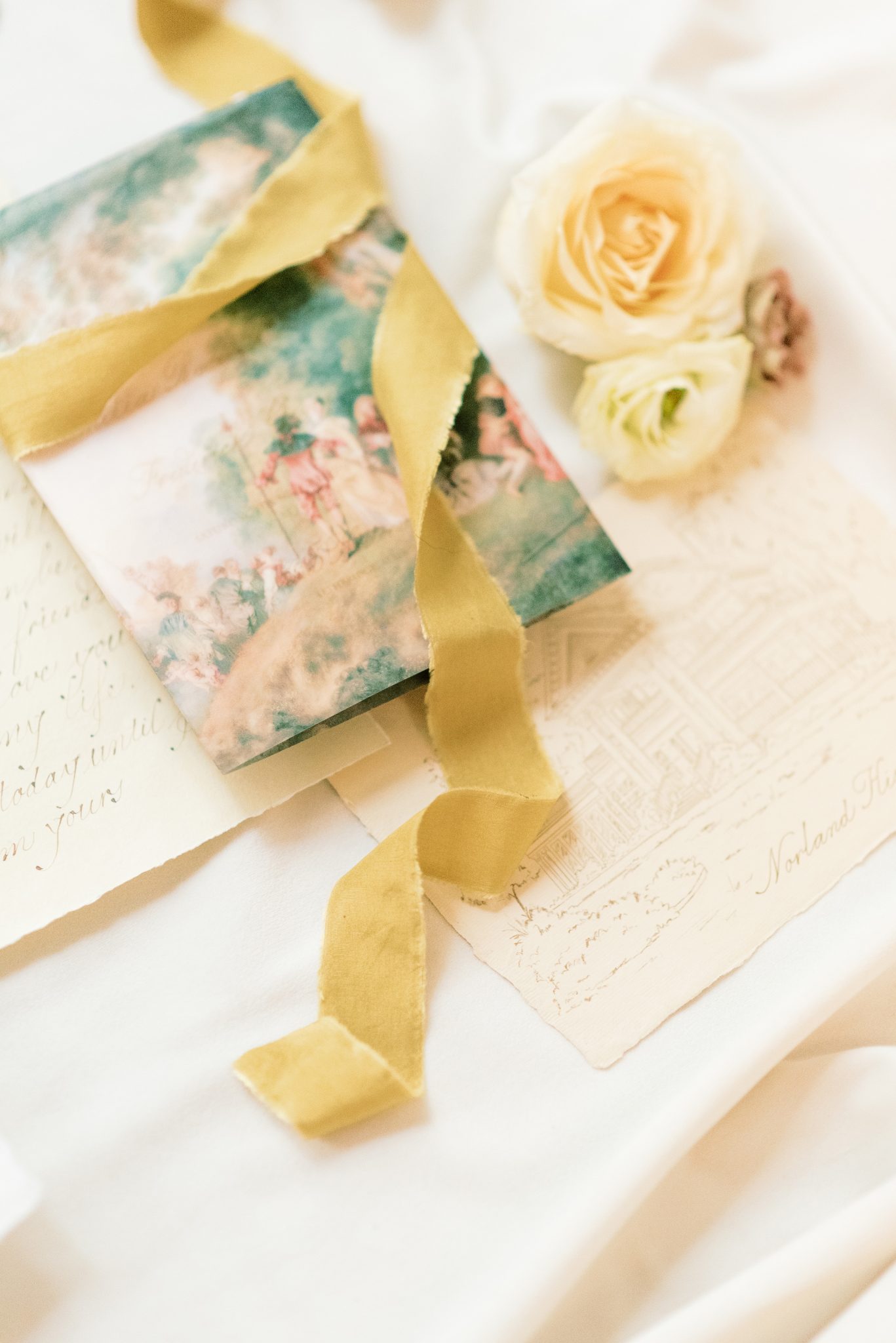 Gold silk ribbon wrapped around wedding details