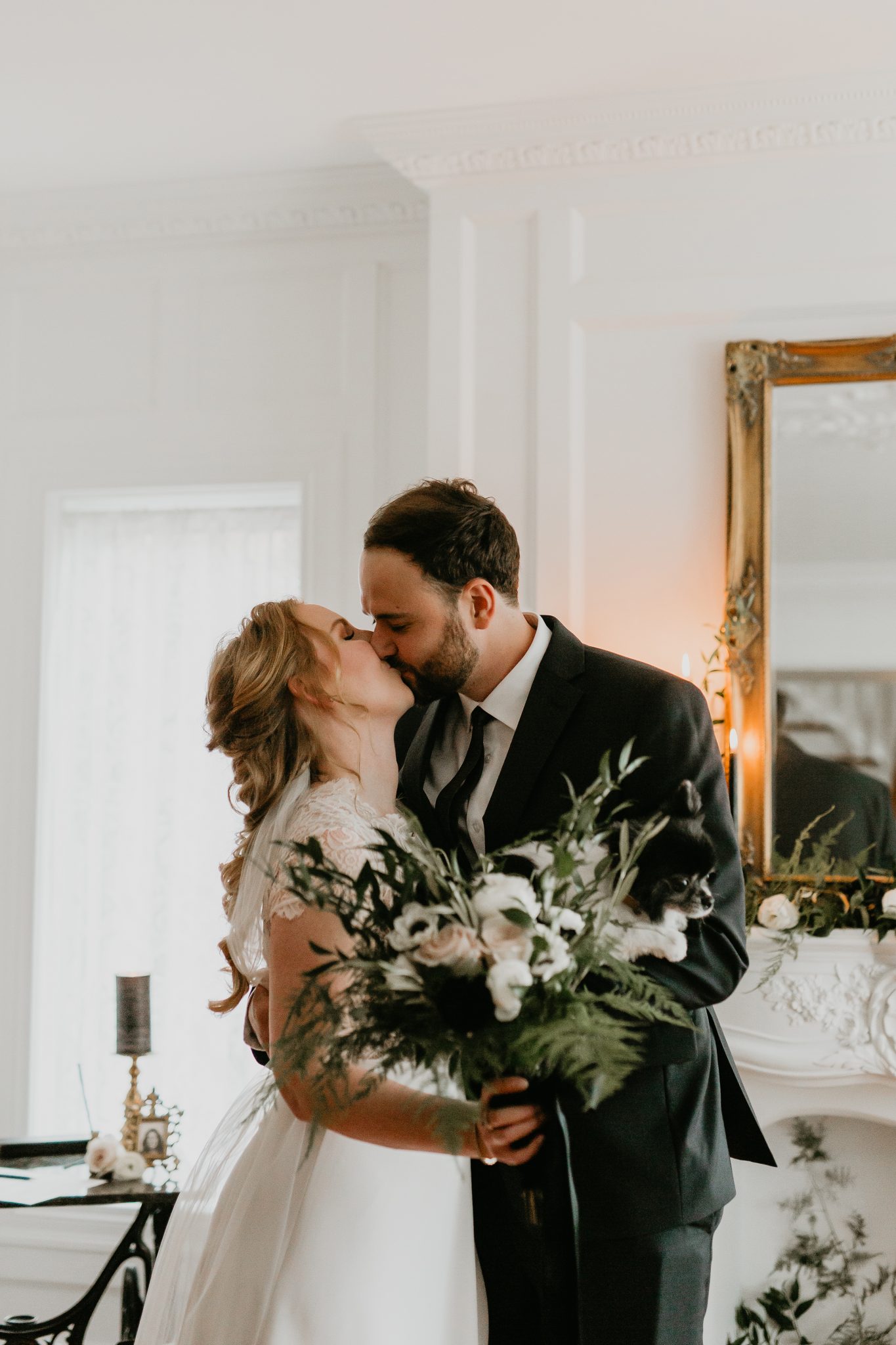 Bride and groom share a kiss in their living room for their minimony