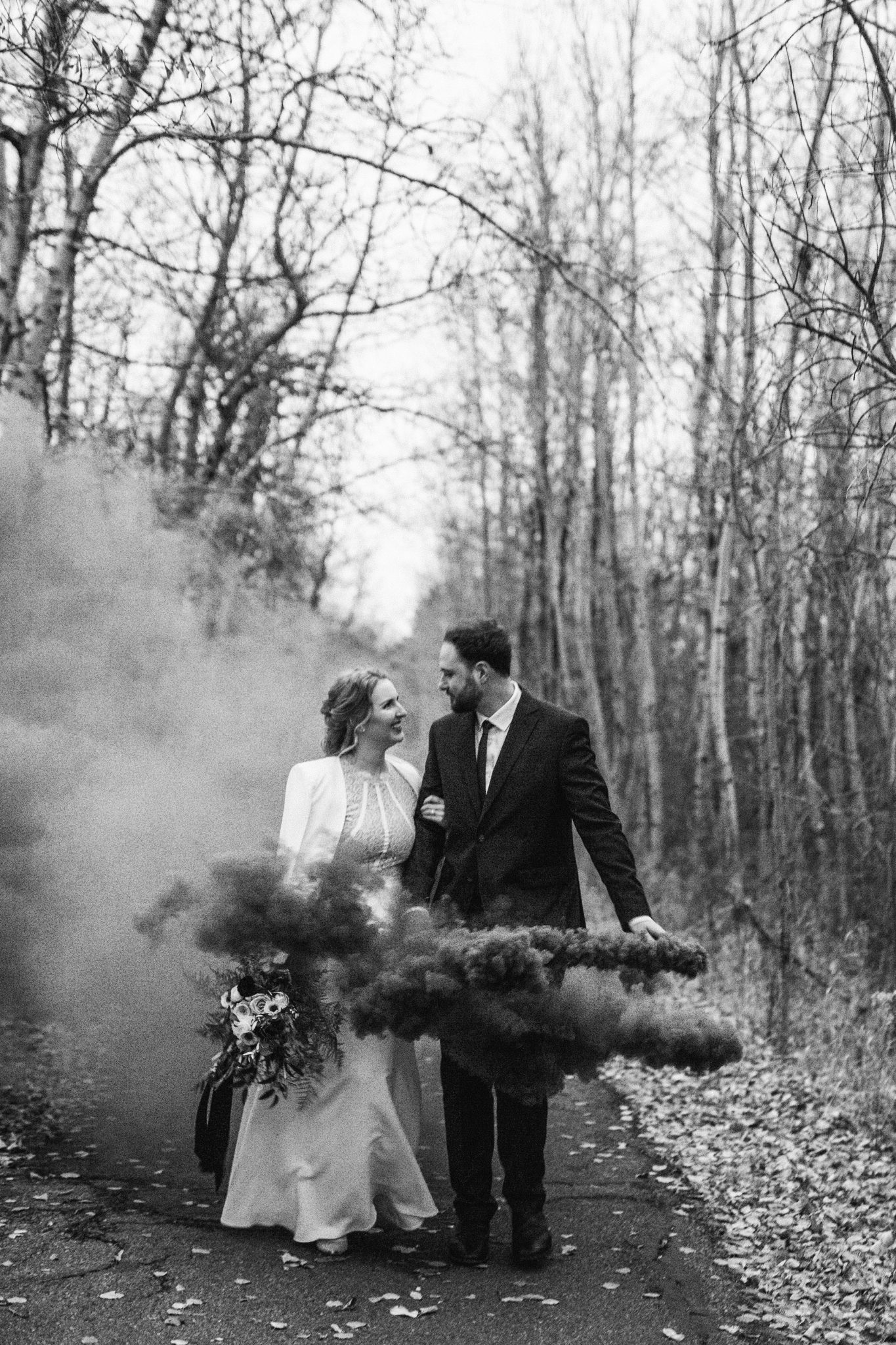 Bride and groom use a smoke bomb for their wedding photos for their October wedding