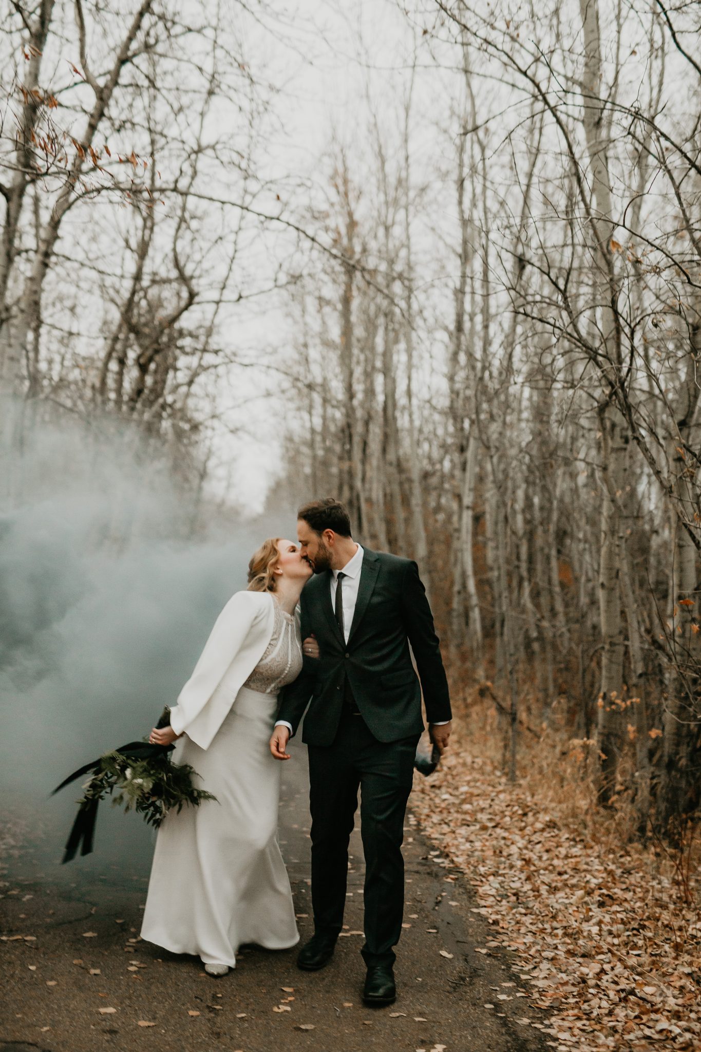 October wedding inspiration with a white crepe wedding jacket and grey smoke bombs