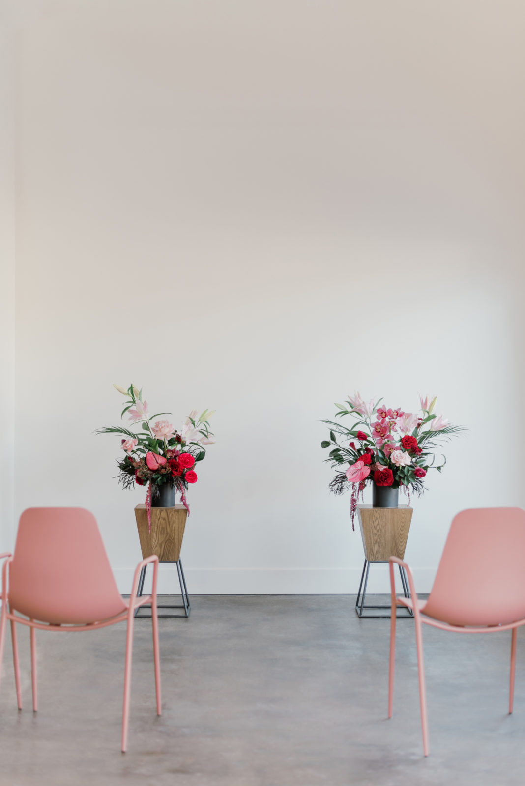 Modern microwedding inspiration with berry florals and pink chairs