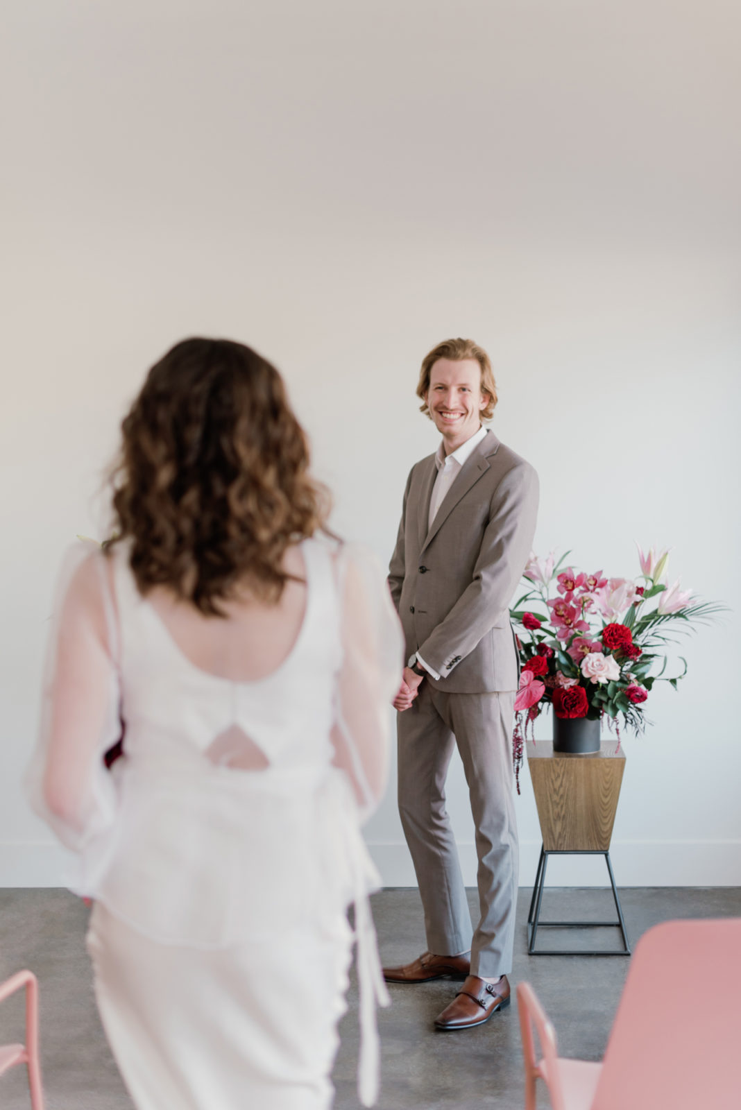Bride walks towards her groom at their modern microwedding