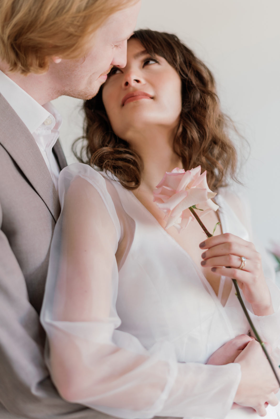 Modern bride and groom wedding attire inspiration with a grey suit and sheer sleeves
