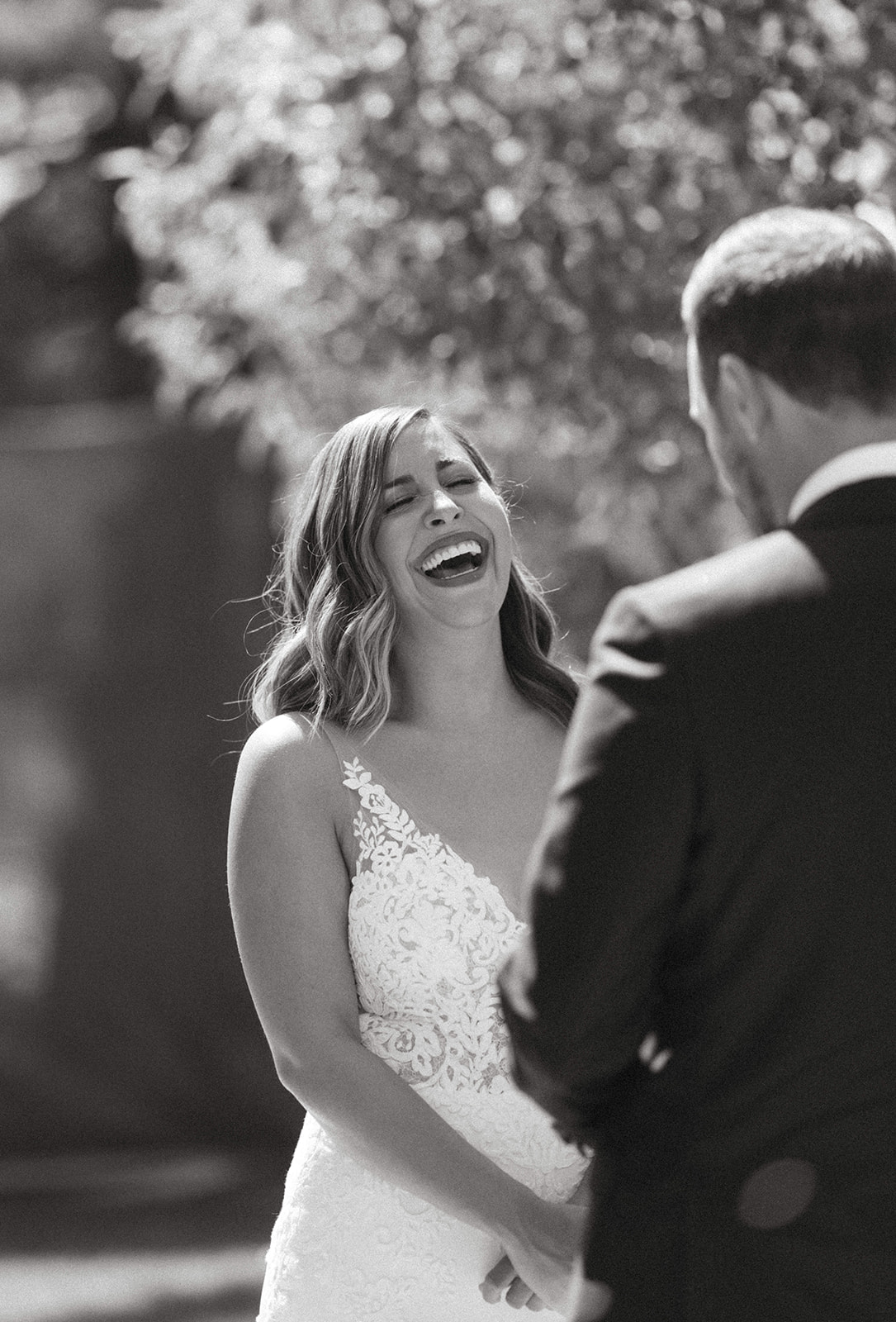 Black and white portrait of a bride and groom sharing their wedding vows at their Deane House wedding ceremony