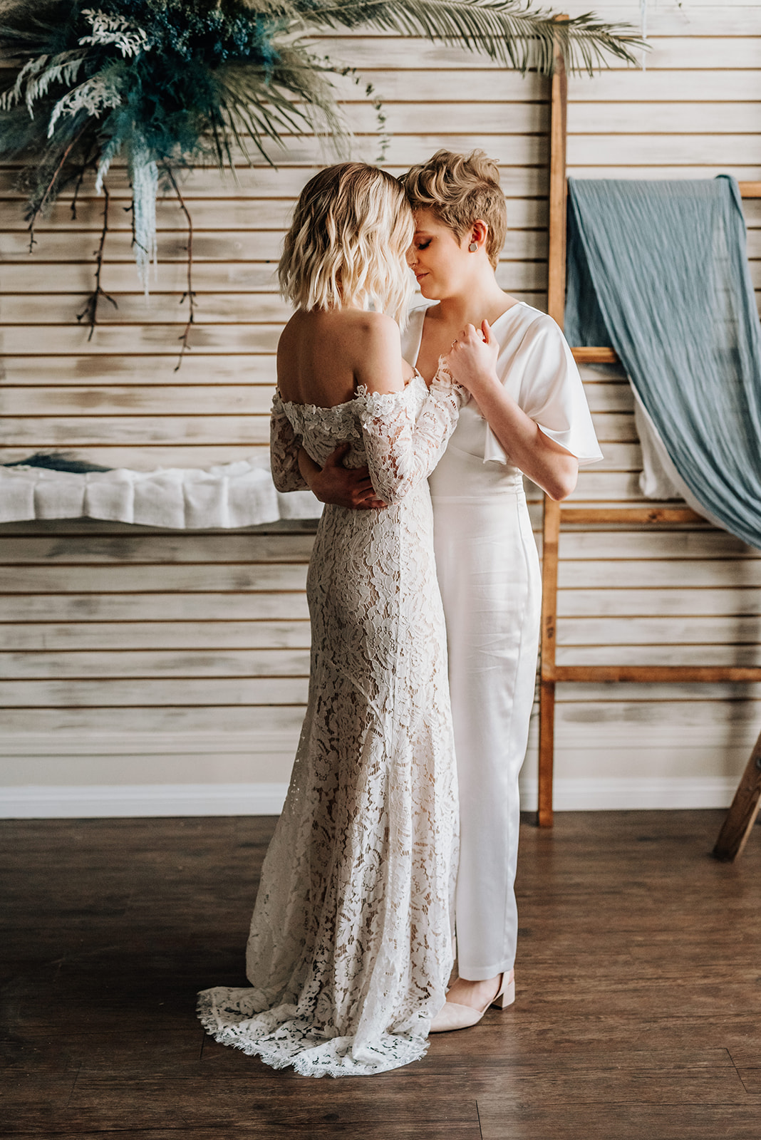 Brides share their first dance in a hair salon decorated for a bohemian elopement 