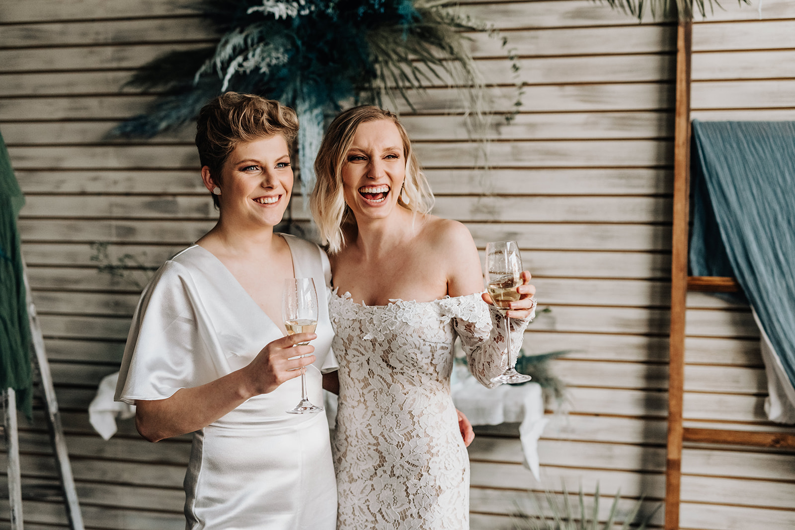 Brides share champagne during their intimate bohemian elopement