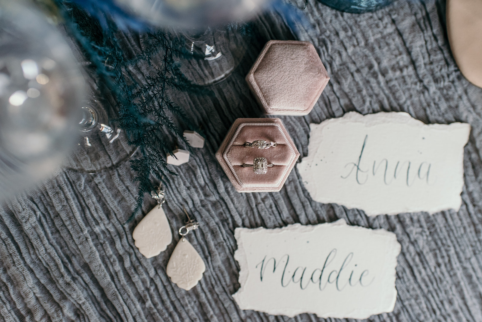 Engagement rings, dusty rose ring box, clay earrings and calligraphy styled place cards