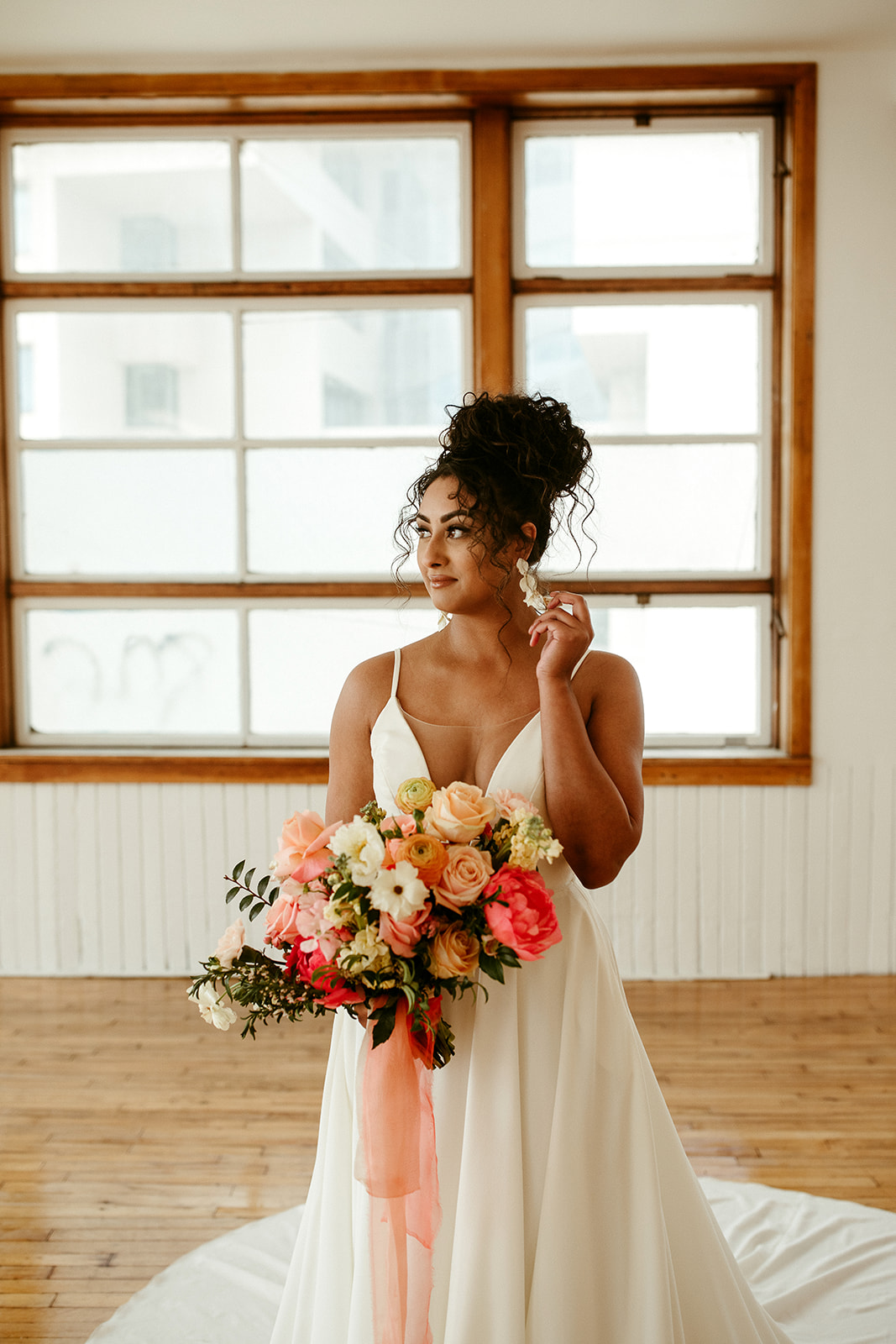 Bold bridal boho updo for the bride with curly hair
