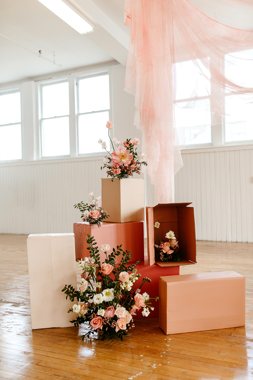 Unique DIY ceremony decor inspiration with painted cardboard boxes and a blush hanging fabric backdrop
