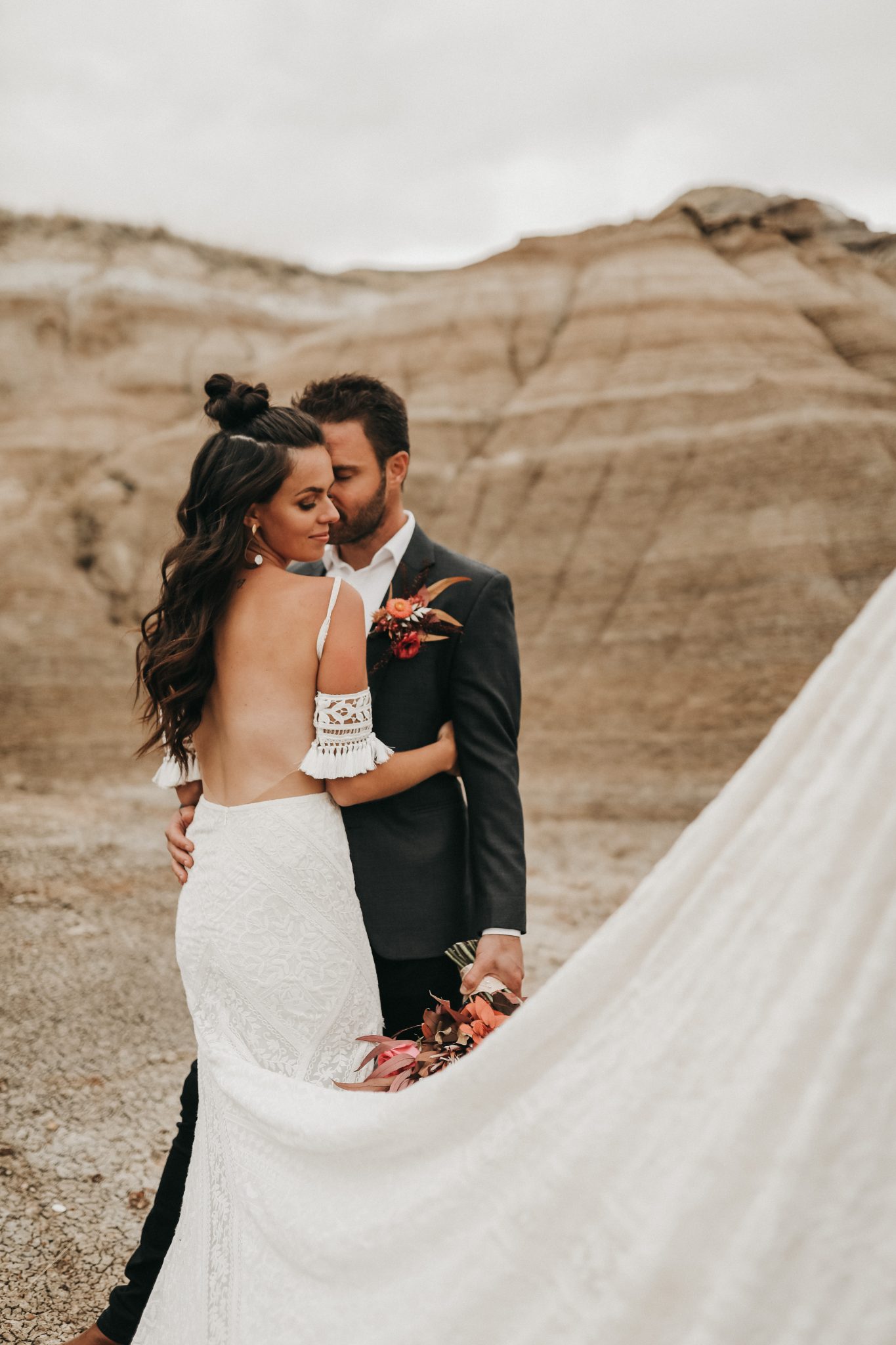 Bride and groom pose in Drumheller Alberta for a Moroccan inspired elopement