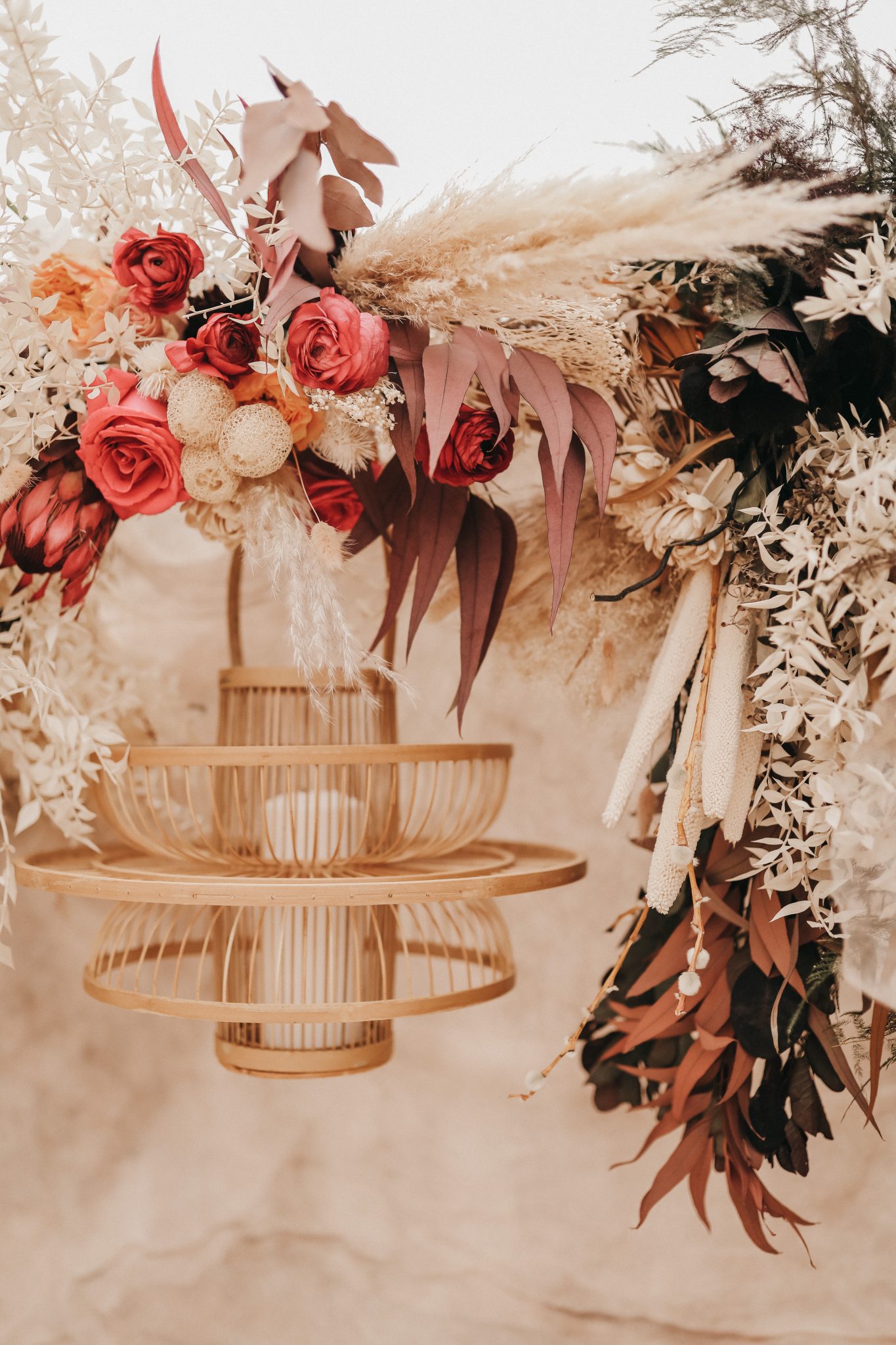 Wicker chandelier hung from a linen tent with boho florals for Moroccan elopement inspiration in Drumheller Alberta