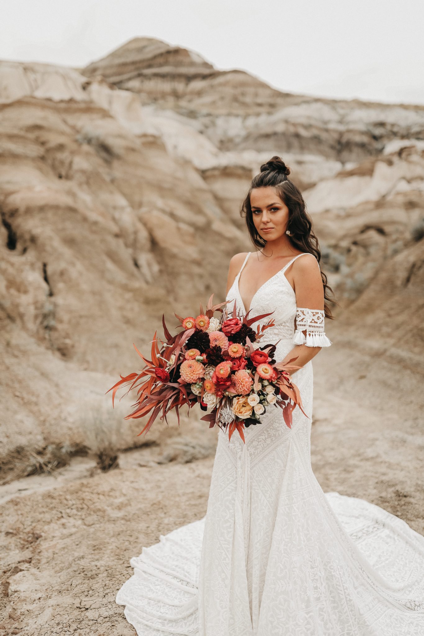 Bride poses with boho bridal bouquet featuring terracotta hues for a Moroccan inspired elopement