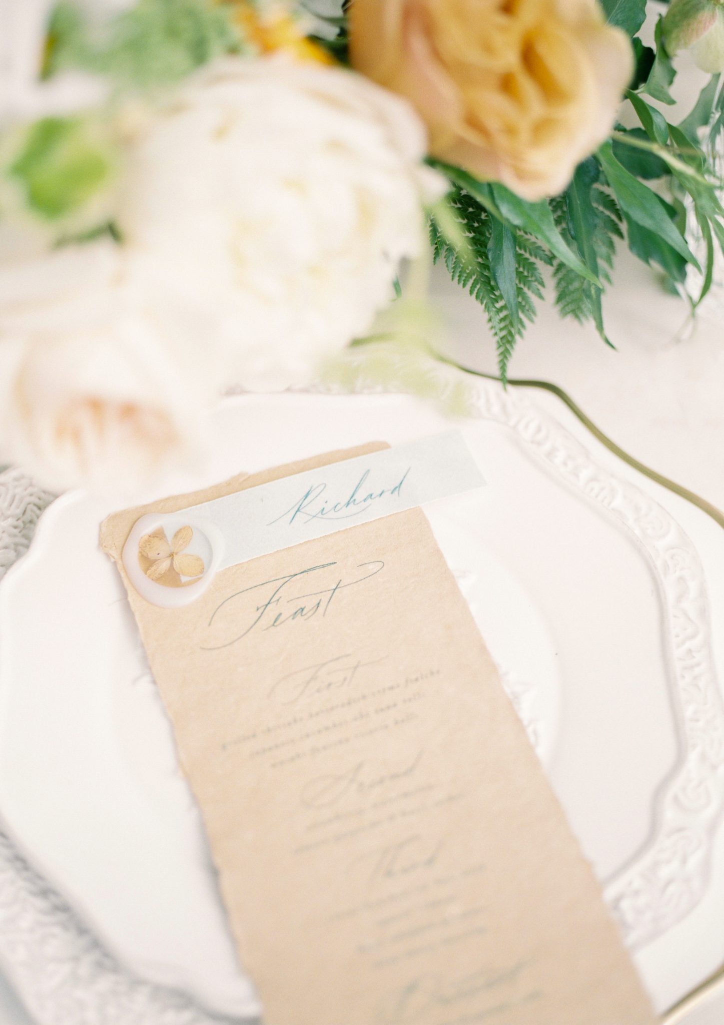 Craft paper wedding menu inspiration with orange and white floral accents
