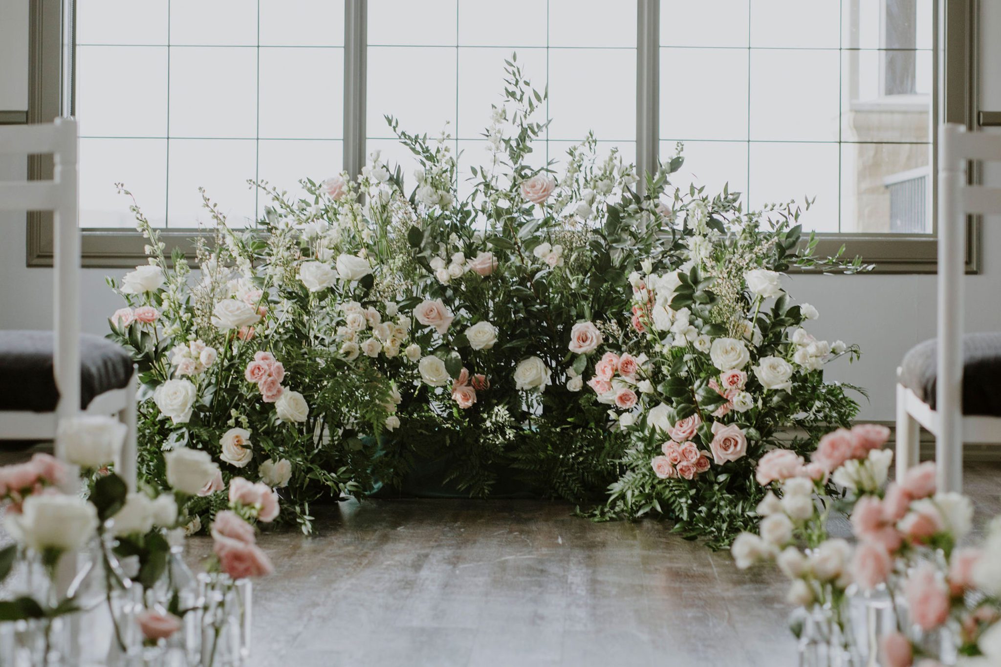 Gardenesque and feminine florals for a wedding ceremony decor at an Alberta wedding venue 