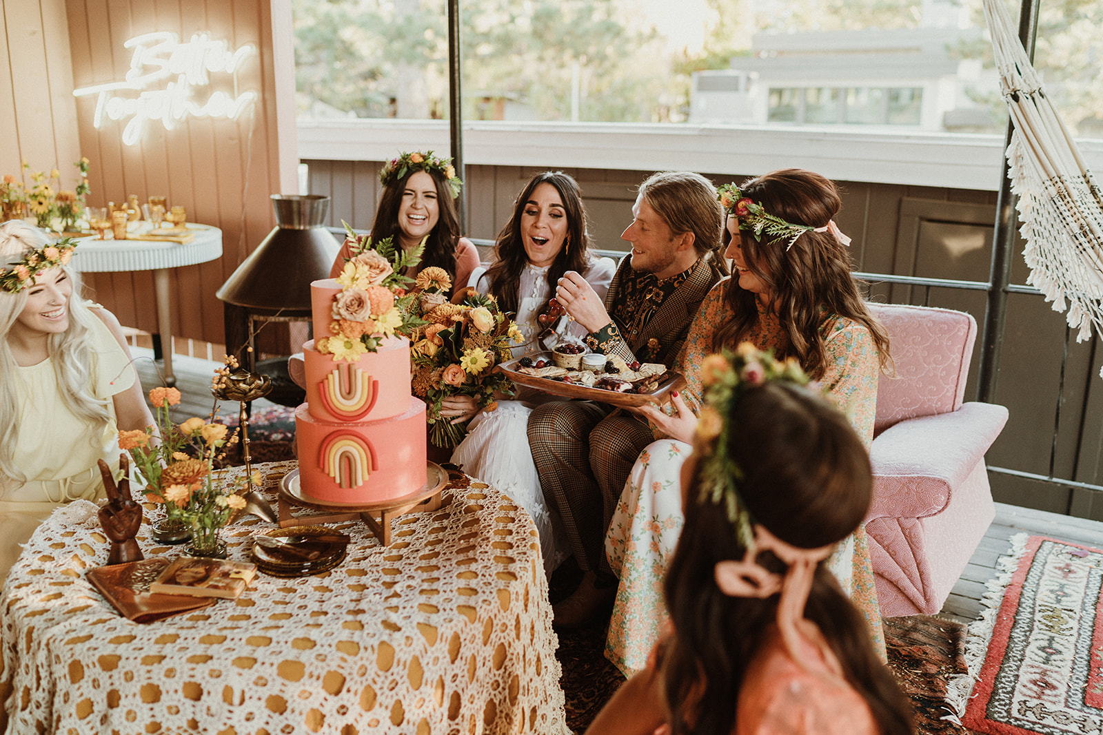 70's inspired wedding party shares food and cake on a retro wedding day