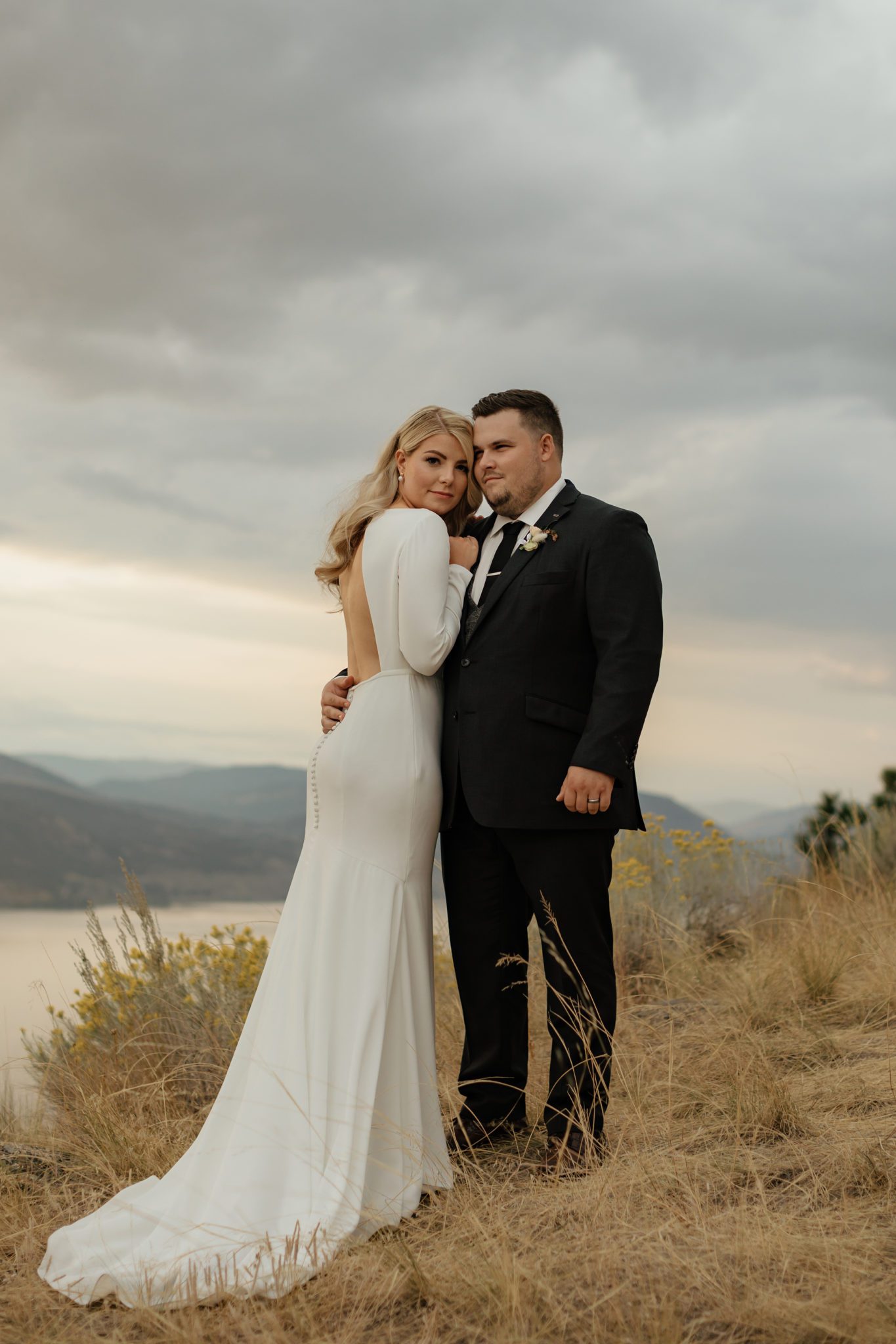 Romantic portrait of bride and groom on their wedding day overlooking the Okanagan Valley