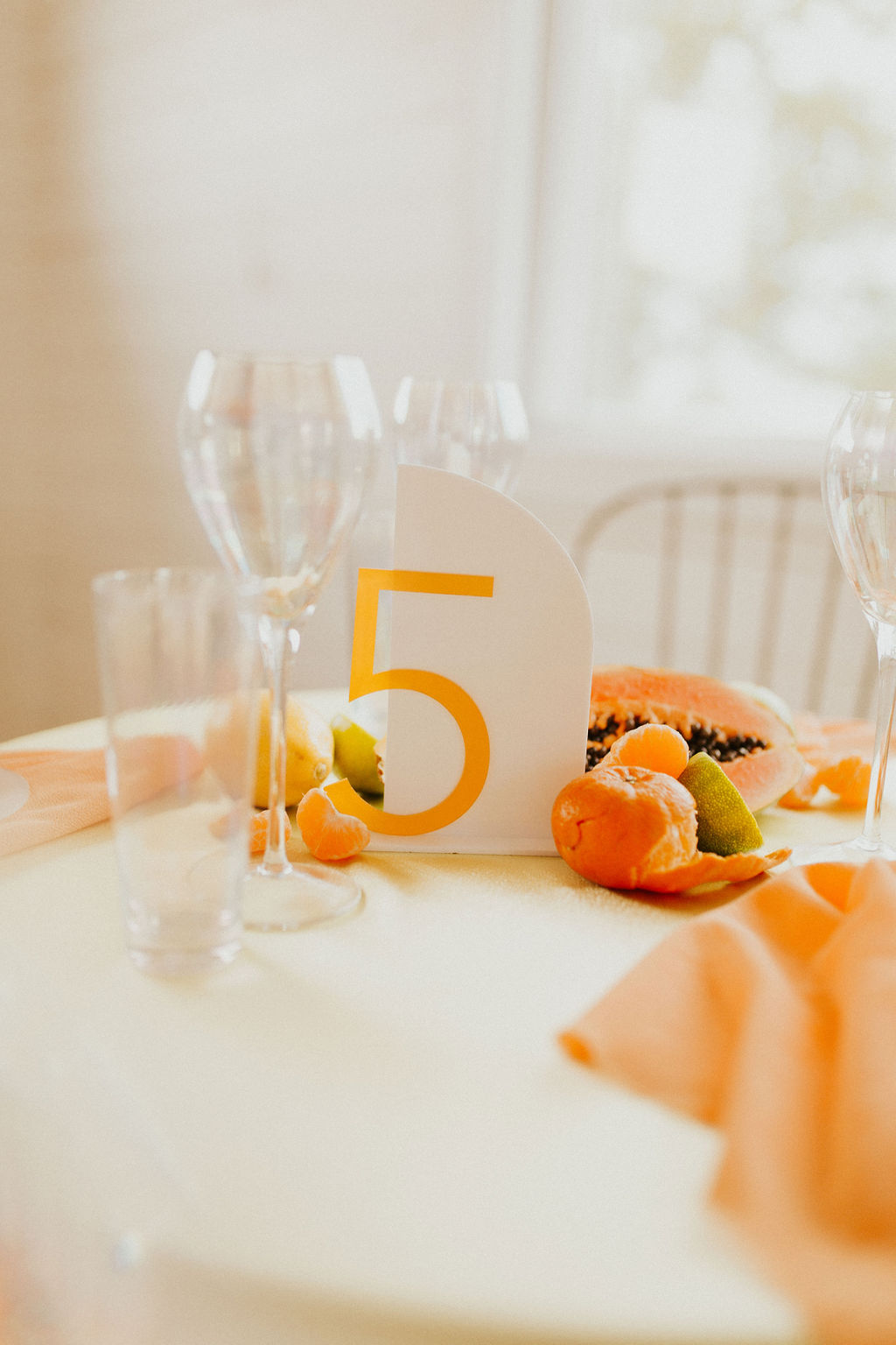 Wedding table number inspiration in a bold tangerine hue