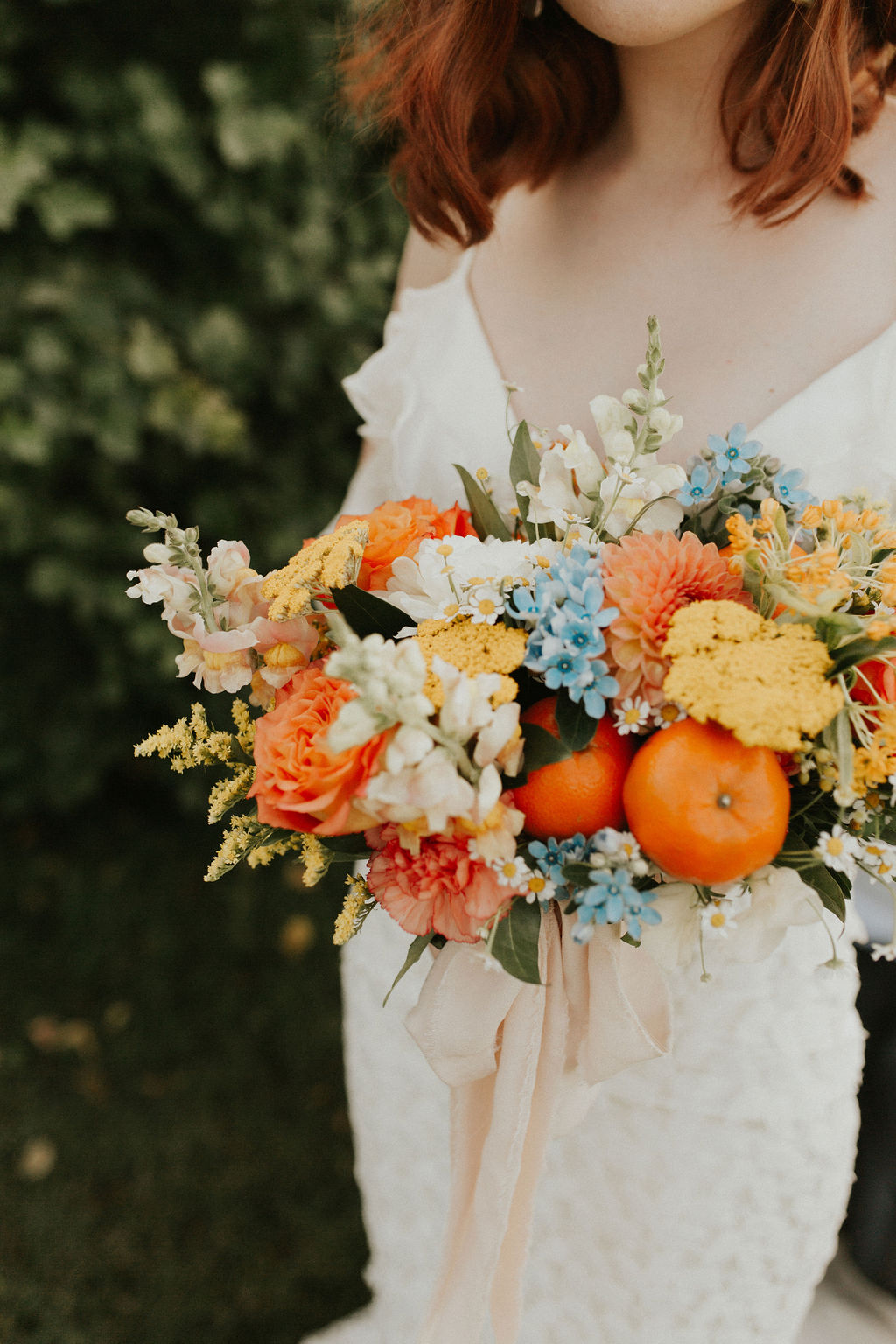 Tangerine inspired bridal bouquet with orange, peach and blue hues
