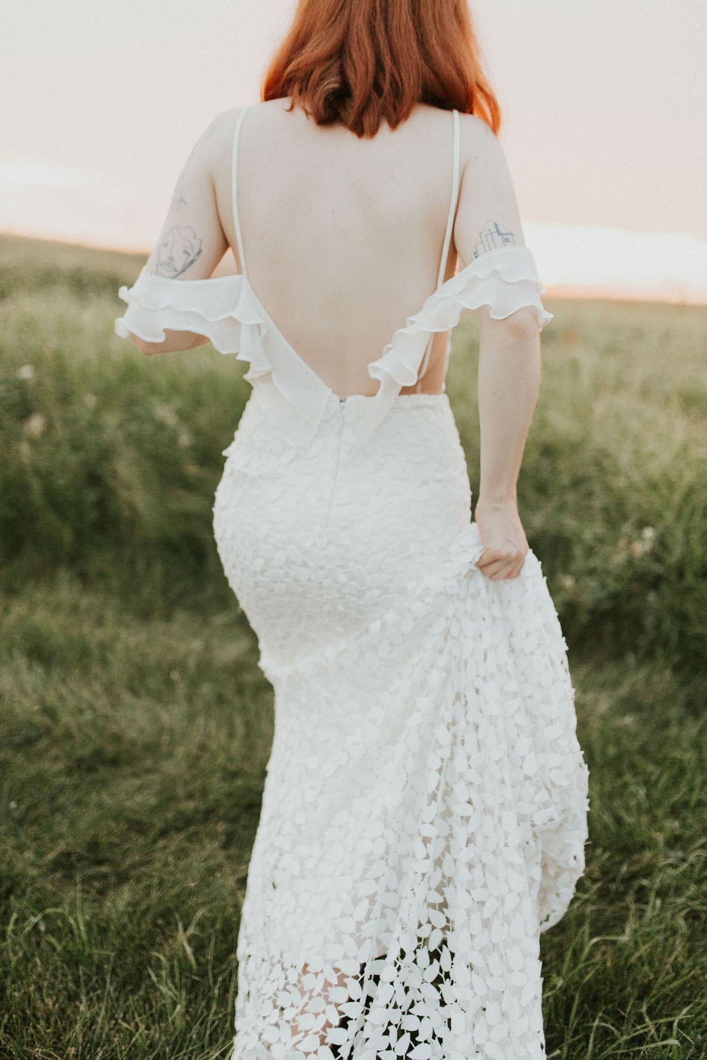 Dreamy wedding dress with off the shoulder ruffled sleeves, delicate lace details and a stunning back