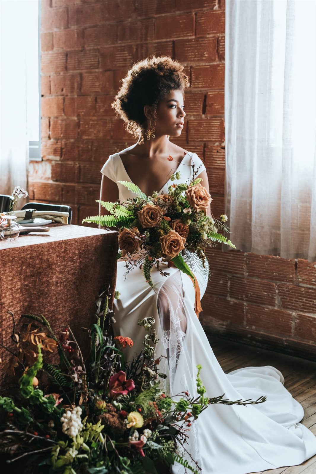 Bridal editorial at Bridgette Bar in Calgary Alberta featuring a sleek gown, earthy fall colours and wild organic florals