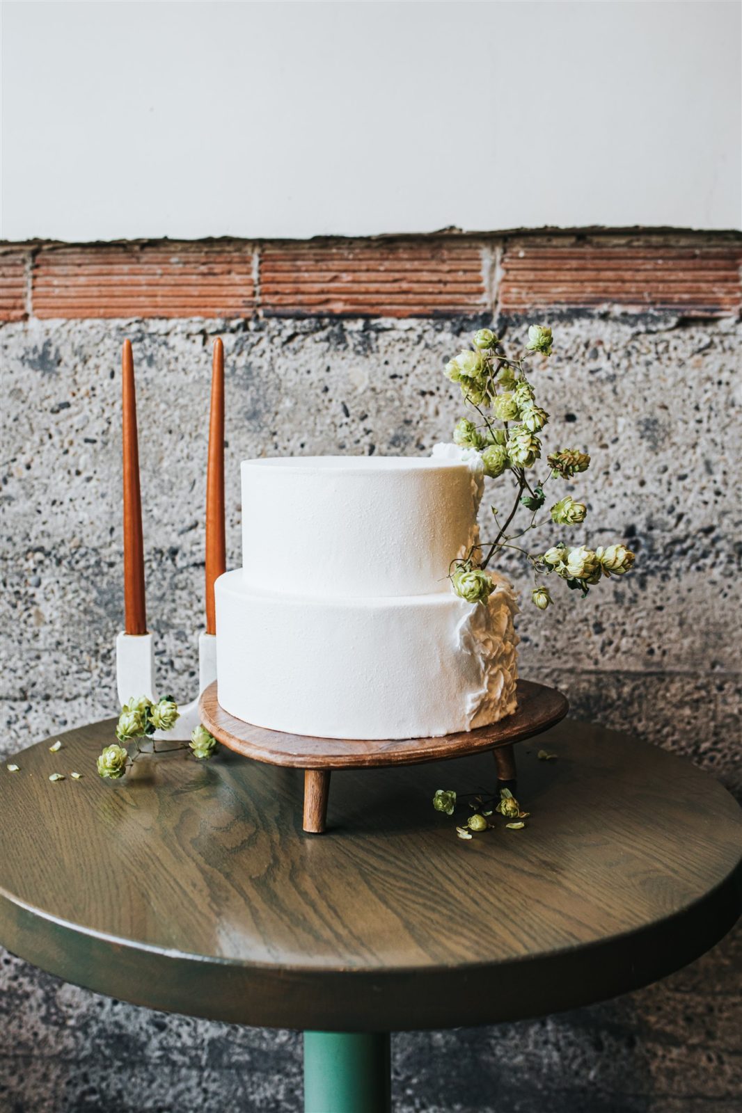 Minimal two tiered white cake with wild and organic floral styling