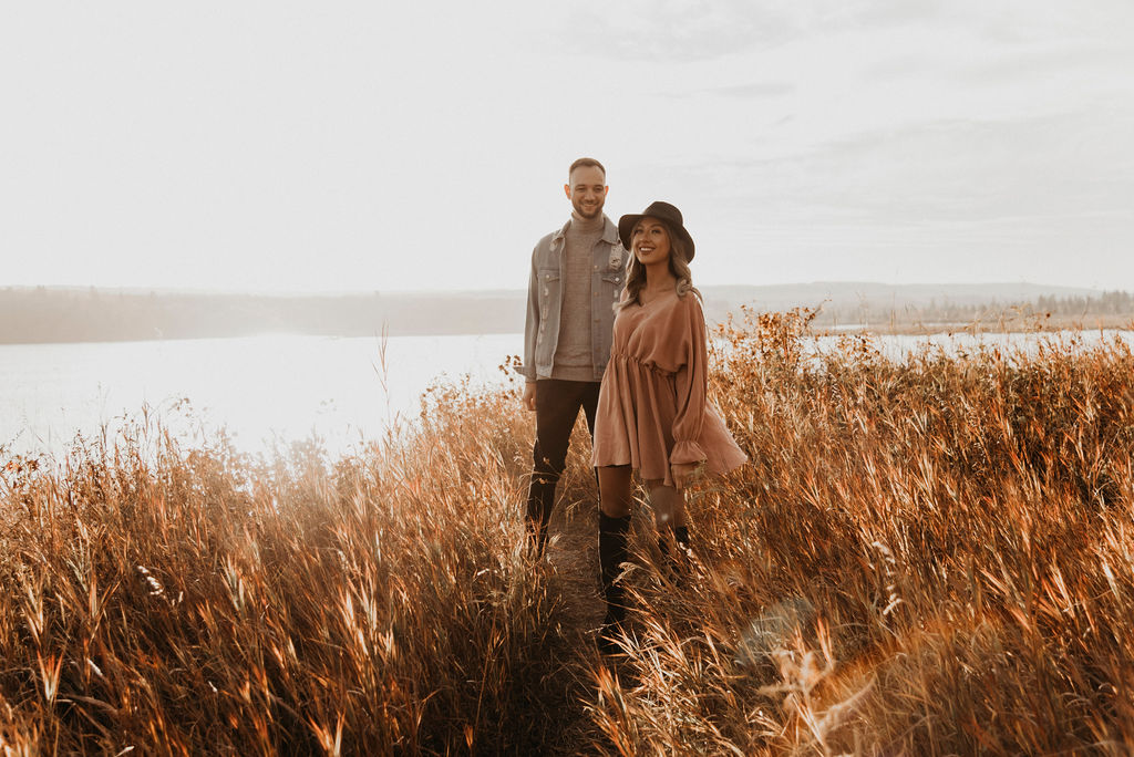 Sunset engagement session in a field near a lake Calgary Alberta