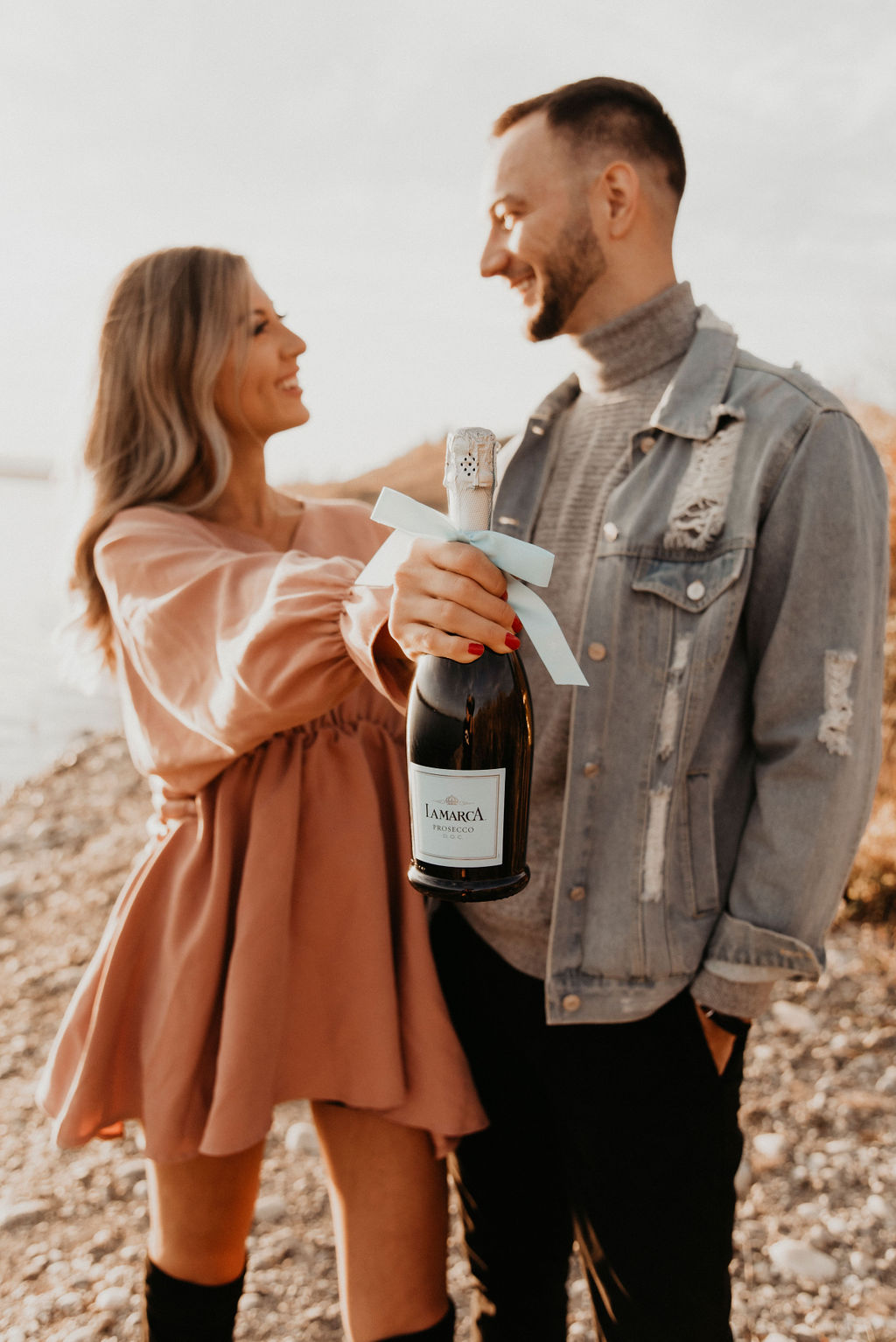 Sunset engagement session with a bottle of La Marca