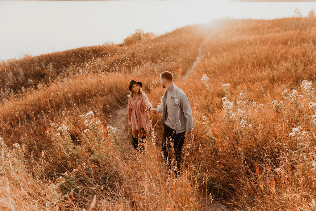 Dreamy sun-kissed engagement session in a Calgary Alberta grassy field