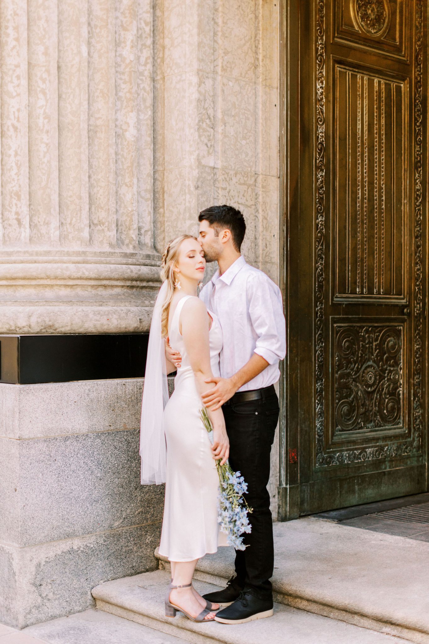 Modern elopement couple pose on the streets of downtown Calgary for this elopement inspiration shoot with hints of a European getaway