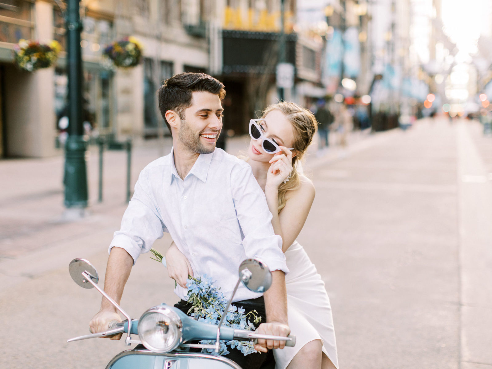 Modern bride and groom ride a blue vespa through the streets of Calgary for this downtown elopement inspiraiton