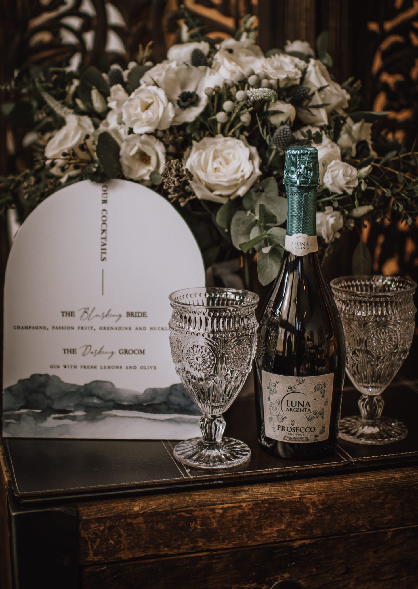 Decor inspiration for a vintage inspired moody winter wedding with a bottle of champagne