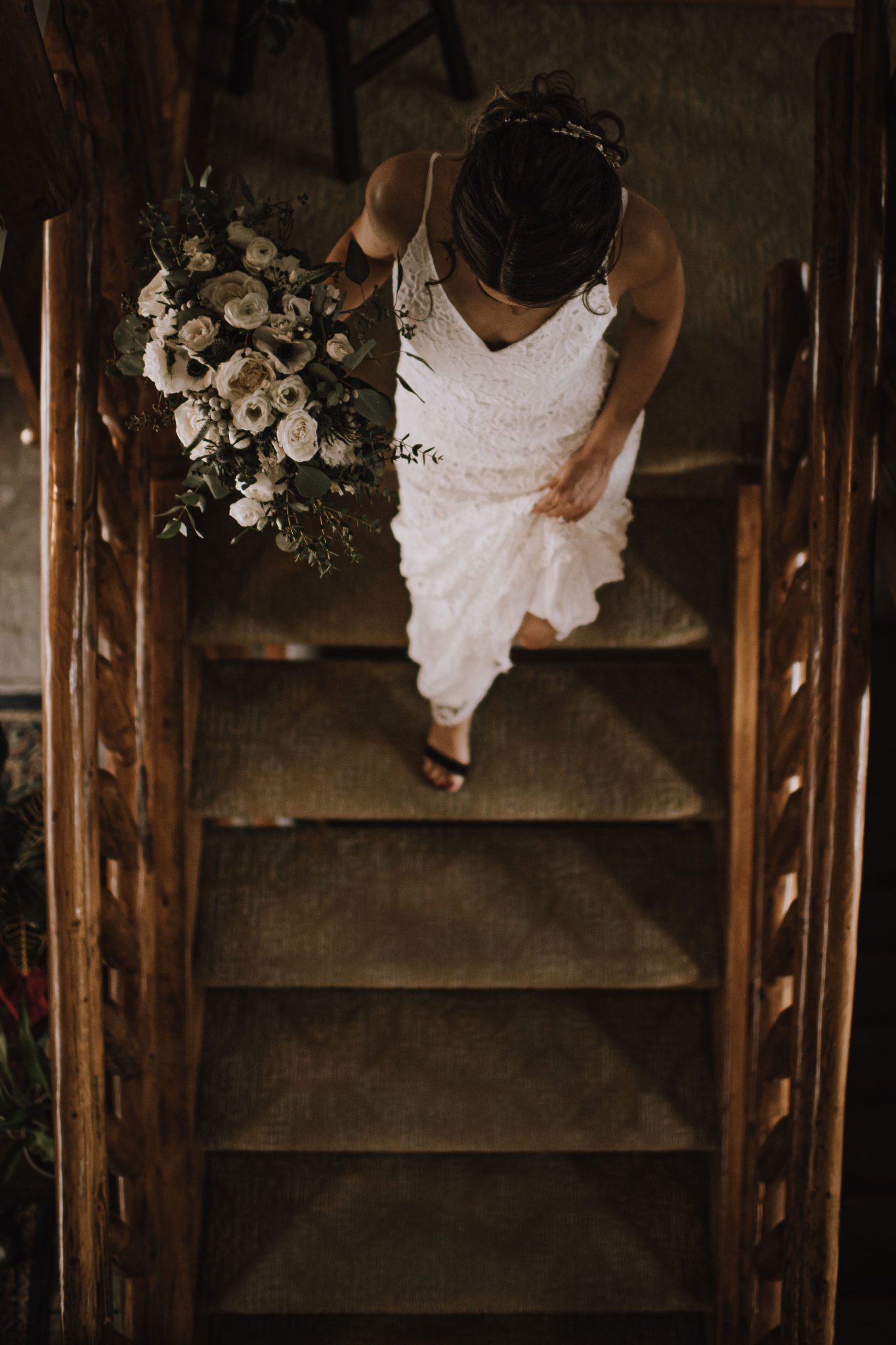 Bride descends the staircase at the A Bear & Bison Canadian Country Inn in Canmore Alberta