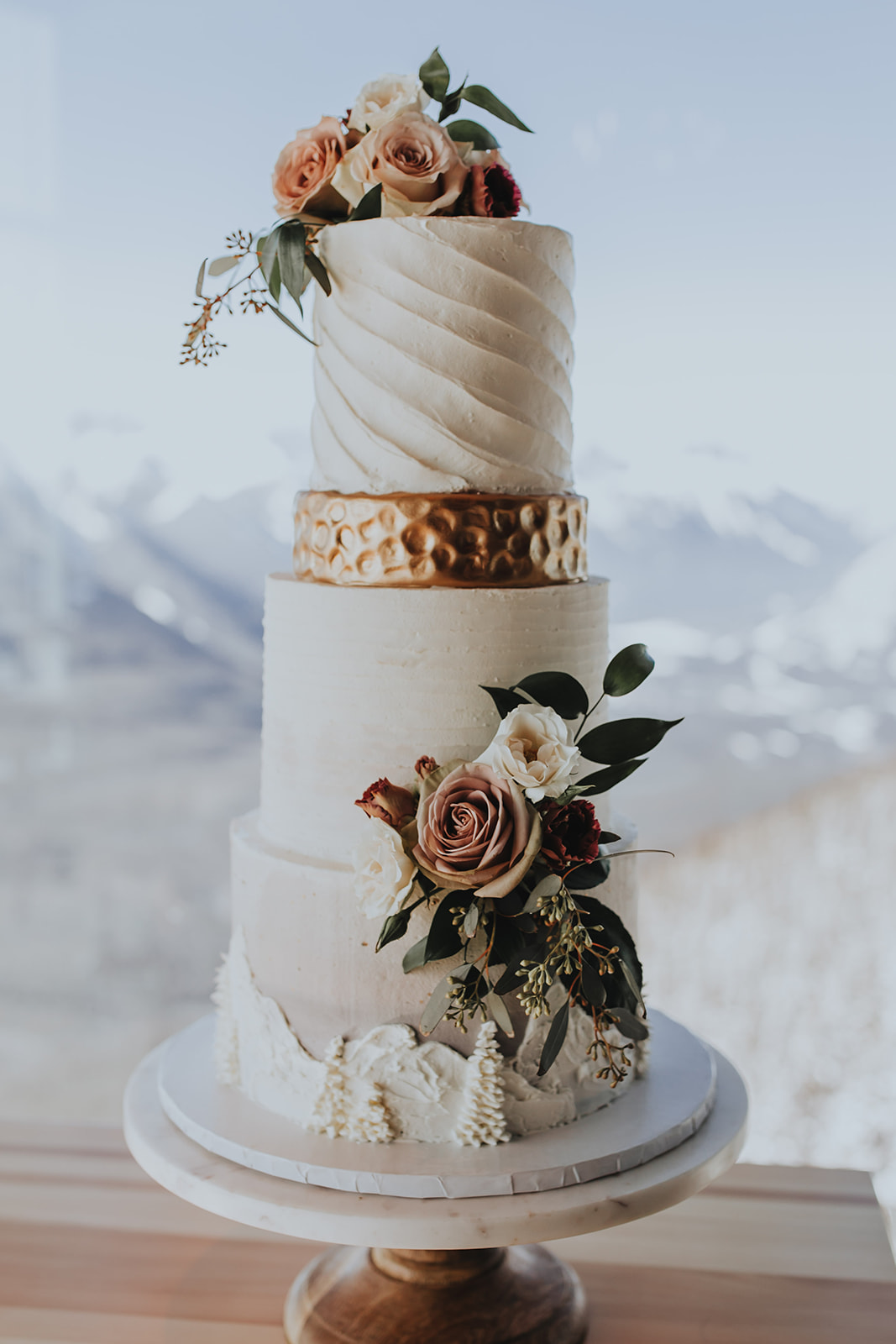Show-stopping wedding cake with metallic and mountain inspired details