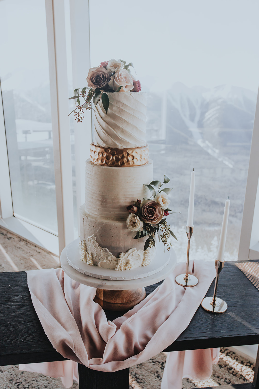 Towering winter and mountain inspired wedding cake with metallic details for a Banff Gondola wedding in the Canadian Rocky Mountains