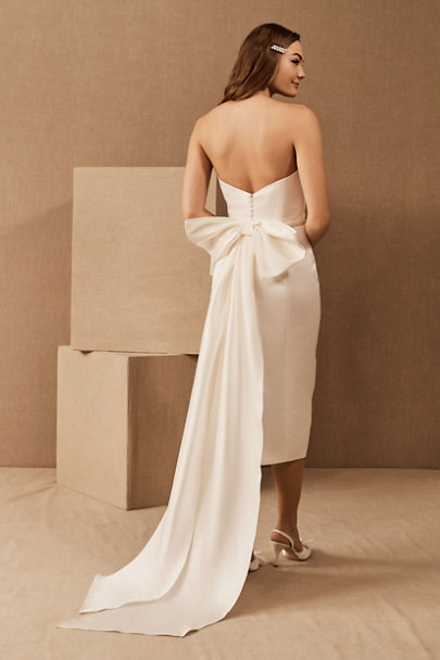 Statement little white dress from Park & Fifth with dramatic trailing bow