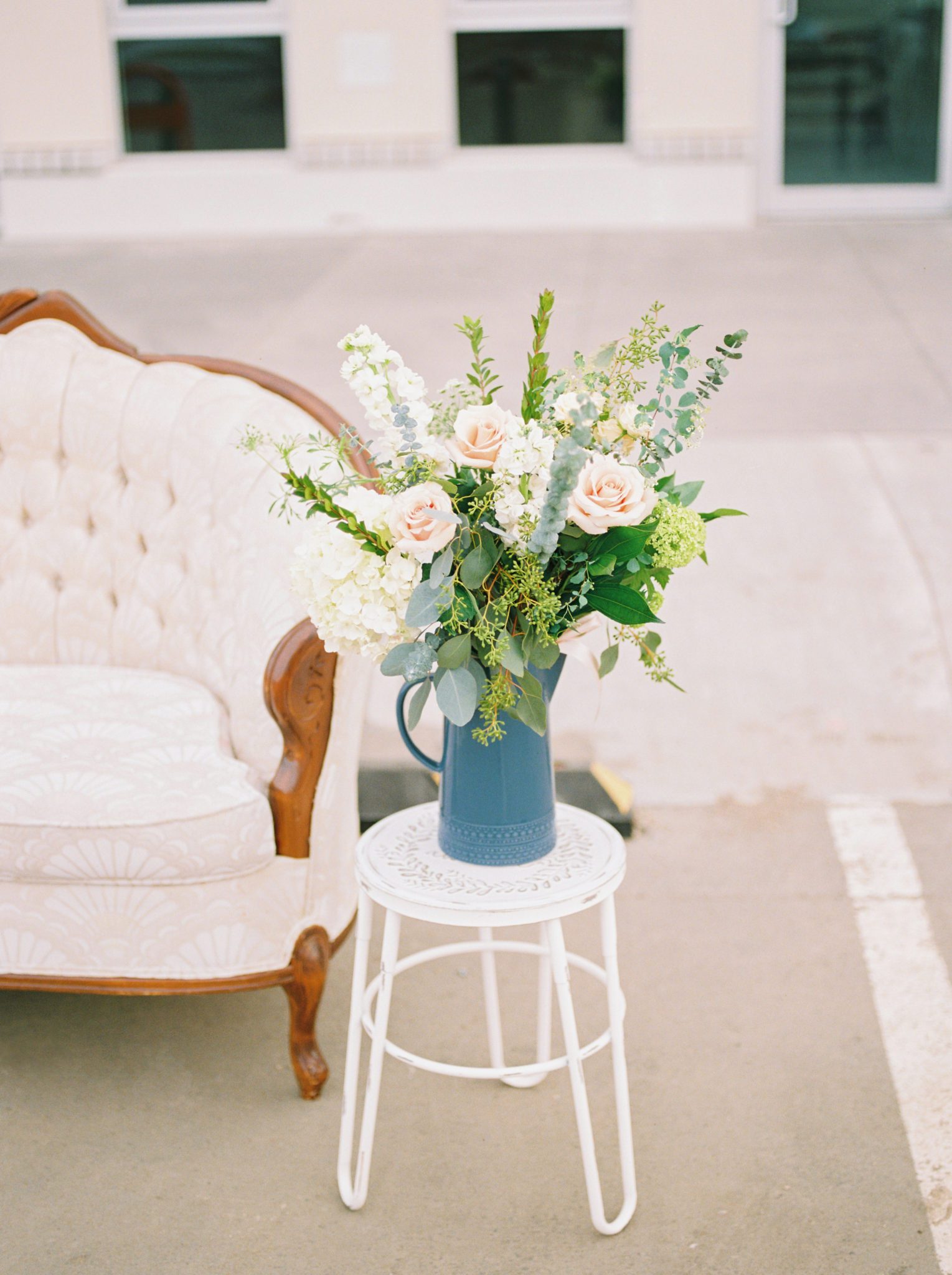 Vintage white sofa, romantic bouquet and other tasteful engagement session prop inspiration
