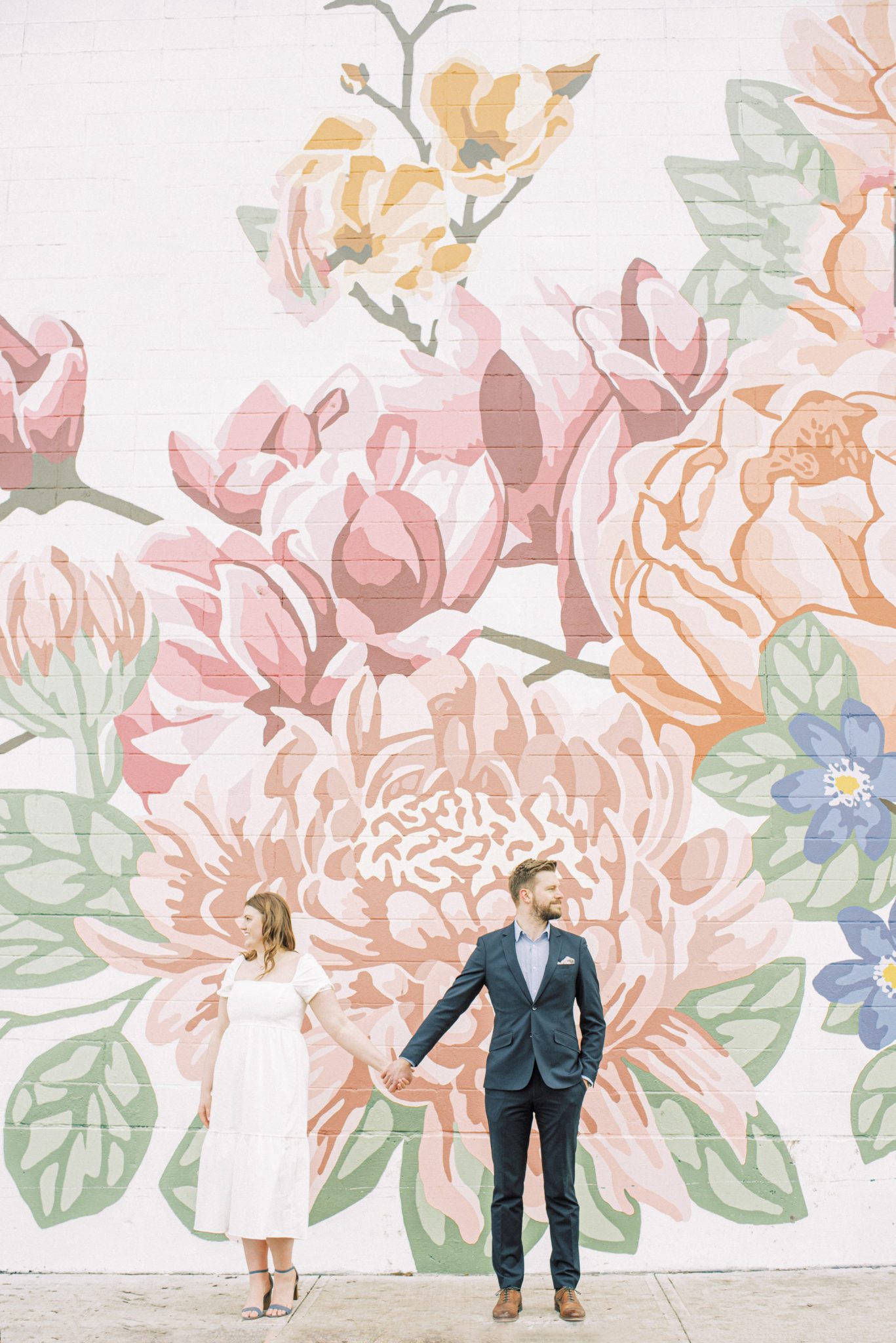 Spring-inspired floral wall mural perfect for romantic and playful engagement photos at Manchester Square in Edmonton Alberta