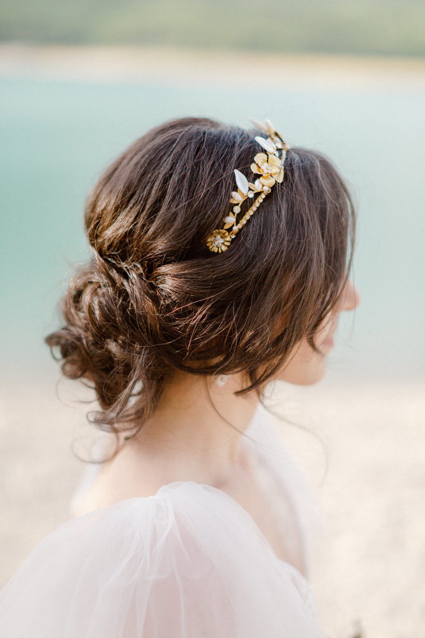 Gold bridal hair accessories with a romantic bridal updo
