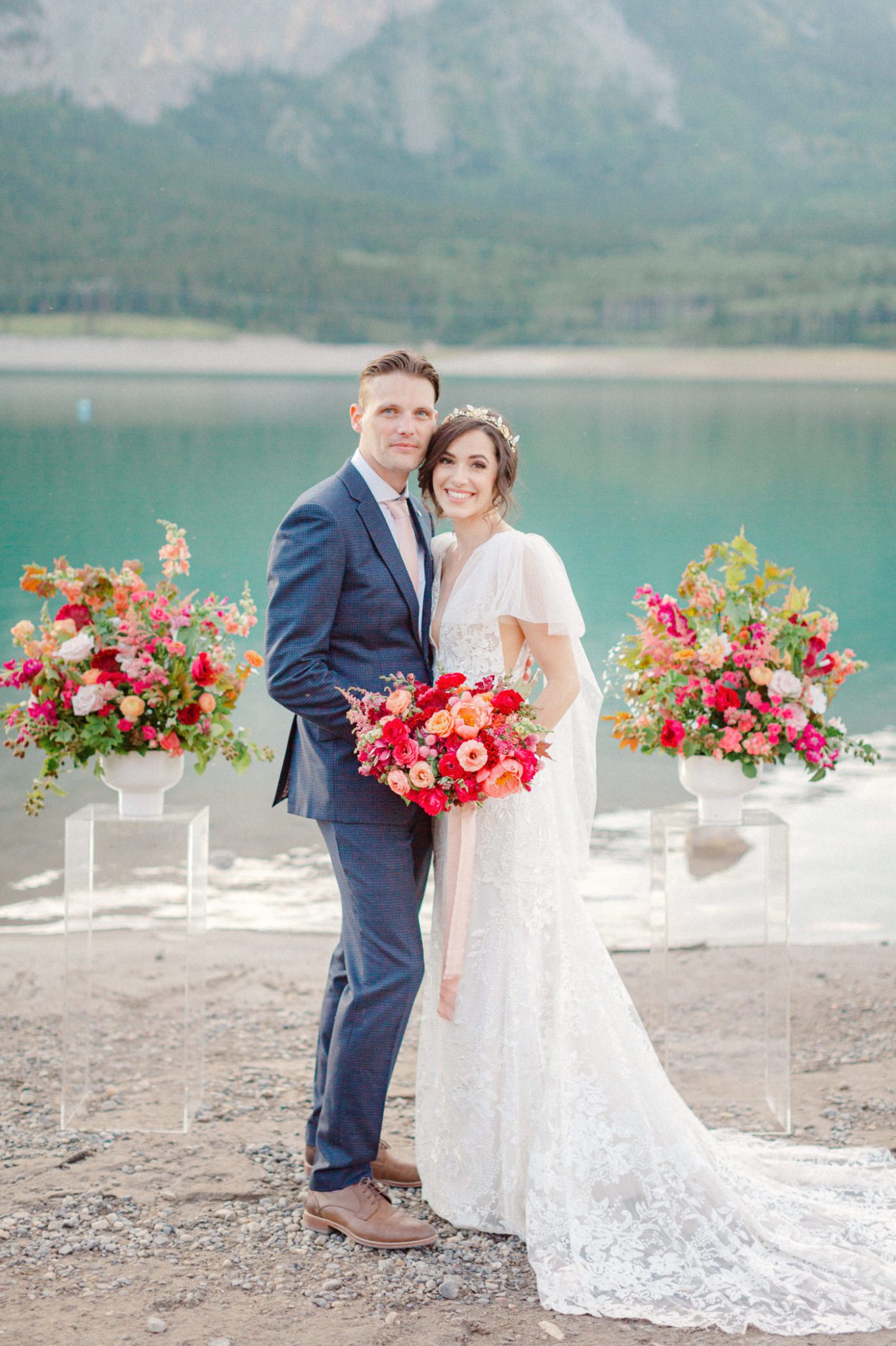 Dreamy summer lakeside wedding inspiration with vibrant orange and red florals