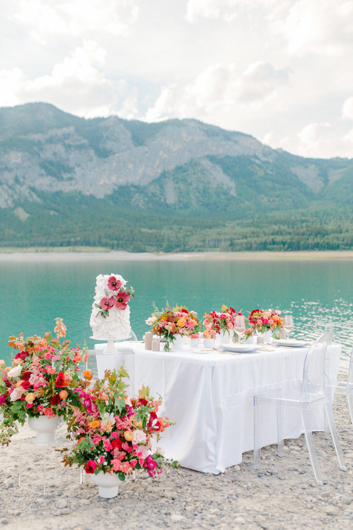 Vibrant floral inspiration in red and orange hues for a dreamy lakeside wedding